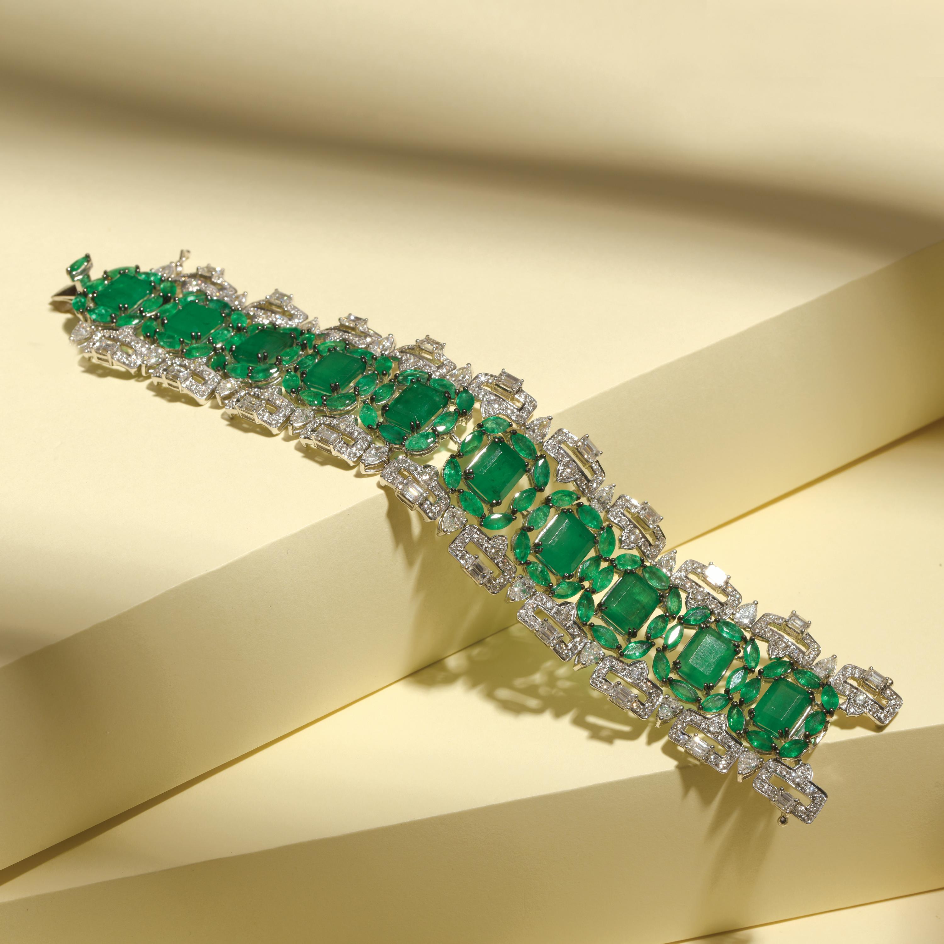 An elegant Art Deco bracelet expertly crafted with octagon and marquise shaped Emeralds  (51.56 carats) bordered with full cut mixed-shaped diamonds (15.22 carats) mounted in 18k white gold.