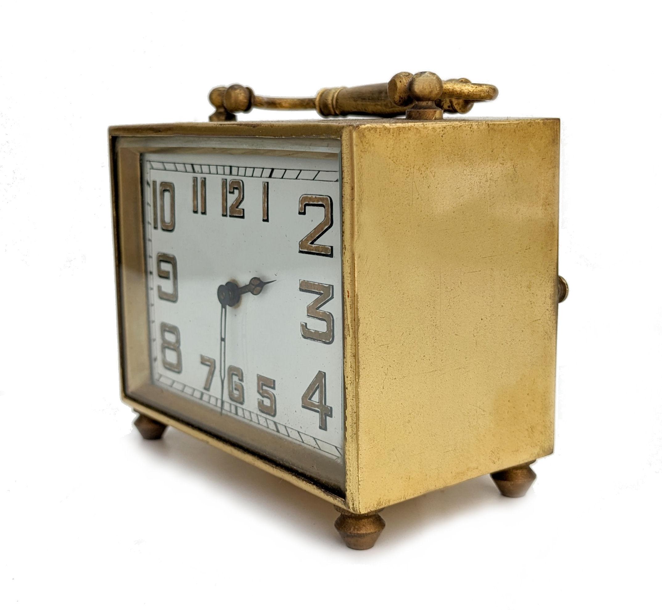 For your consideration is this rather charming and not often found Art Deco French 8 day carriage clock with it's original red leather carry case. The off white enamel dial with Art Deco stylised numerals in gold is cased in a solid brass surround