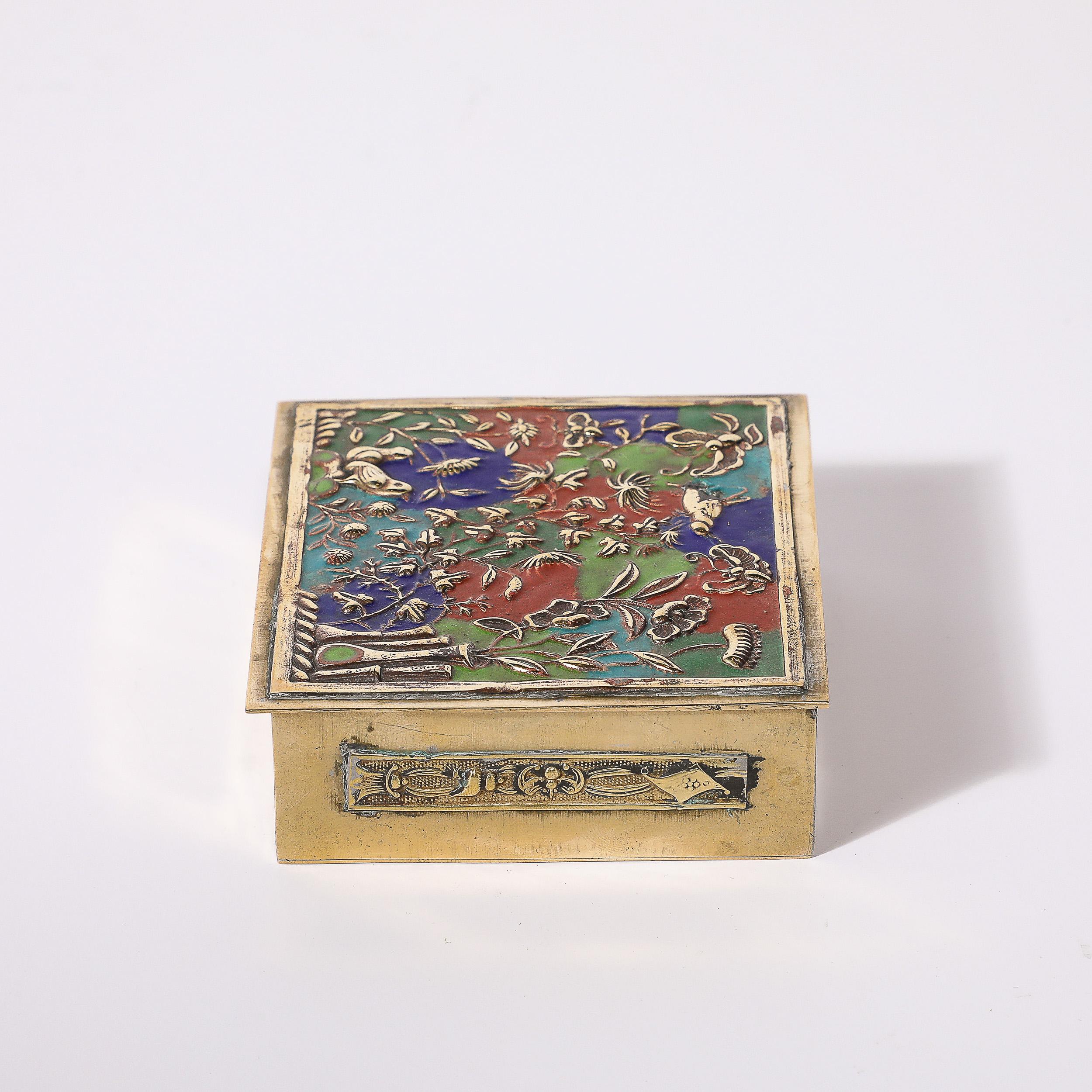This exquisitely detailed and beautifully achieved Art Deco Brass and Enamel Box W/ Naturalist Imagery in Relief Cloisonne originates from Japan, Circa 1930. Features a top composed of raised relief naturalist imagery in brass lined with multicolor