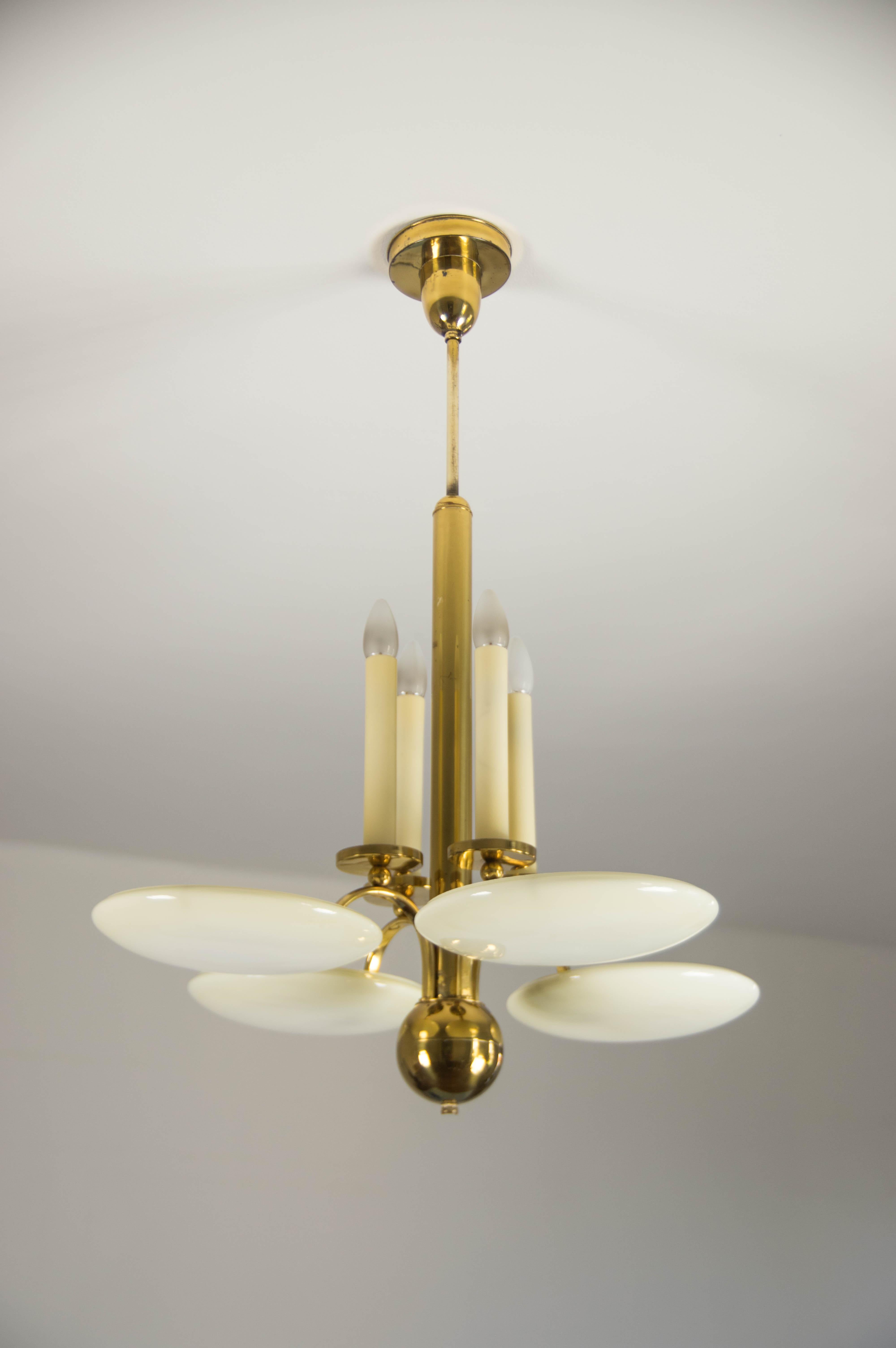 Beautiful Large Art Deco chandelier made of brass plated metal and blown glass ivory color shades.
Item was cleaned polished and rewired. 
Brass plating has minor scratches visible on pictures.
Glass in a perfect condition.
4x40W, E12-E14 bulbs on