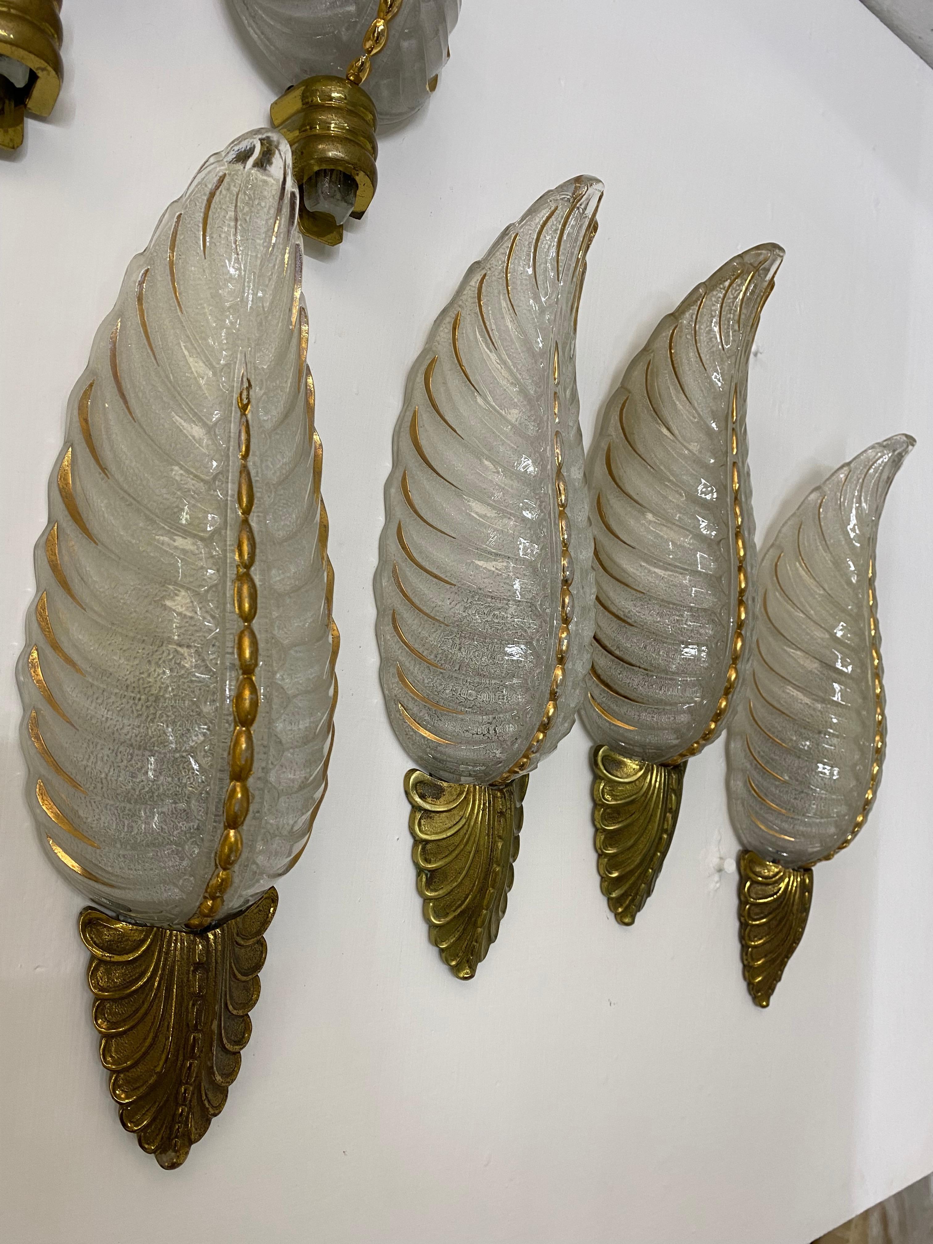 Art Deco sconces in pressed glass and bronze manufactured by Ezan in France circa 1940s 
Priced per pair. 5 pairs available. With slight variations on patination.