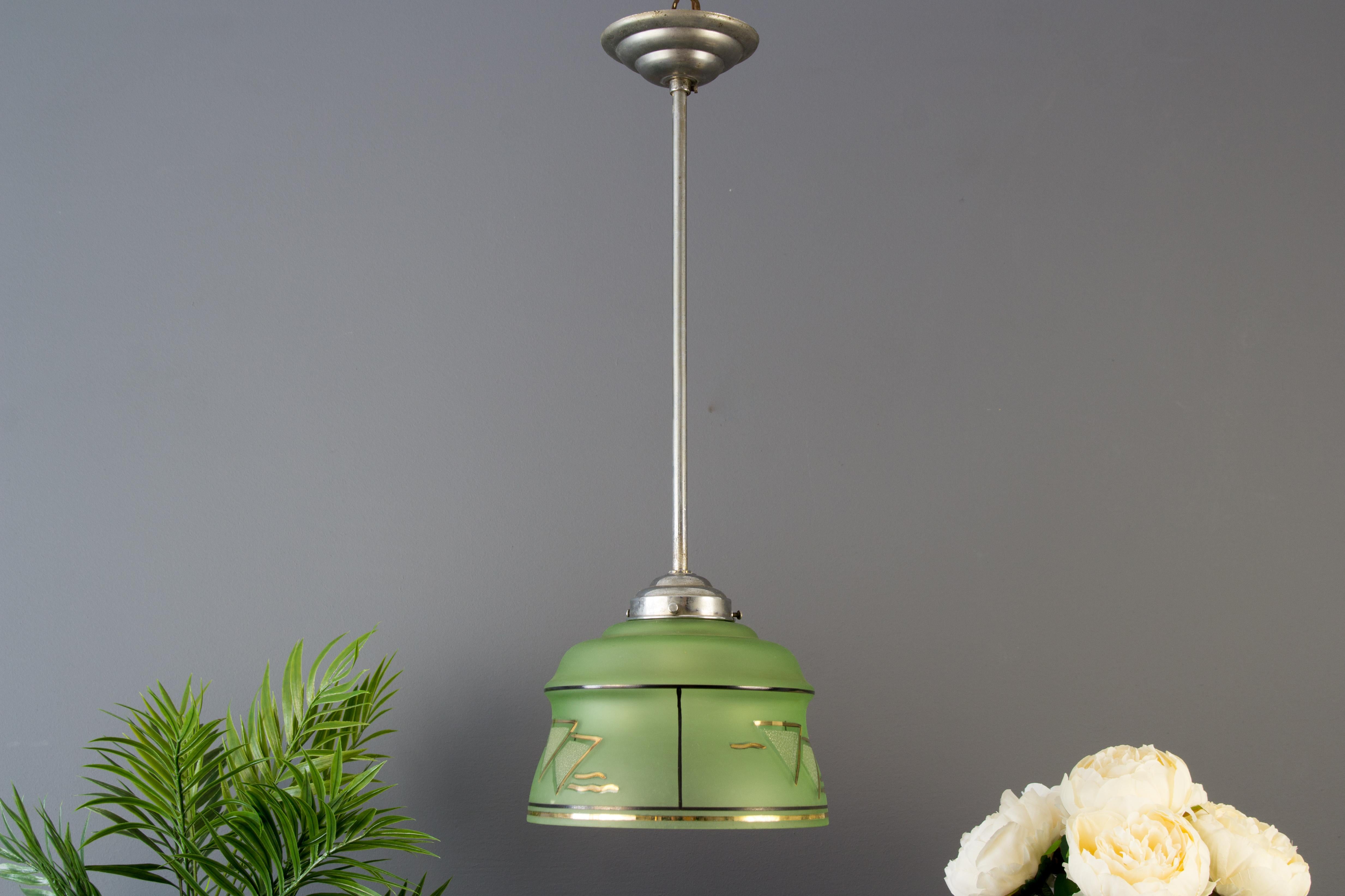 Art Deco brass and green glass pendant, the 1930s
French Art Deco nickeled brass and a green glass pendant from circa the 1930s. One socket for the E 27 (E26) light bulb.
Dimensions: diameter 18 cm / 7.08 in; height 50 cm / 19.68 in.
The light