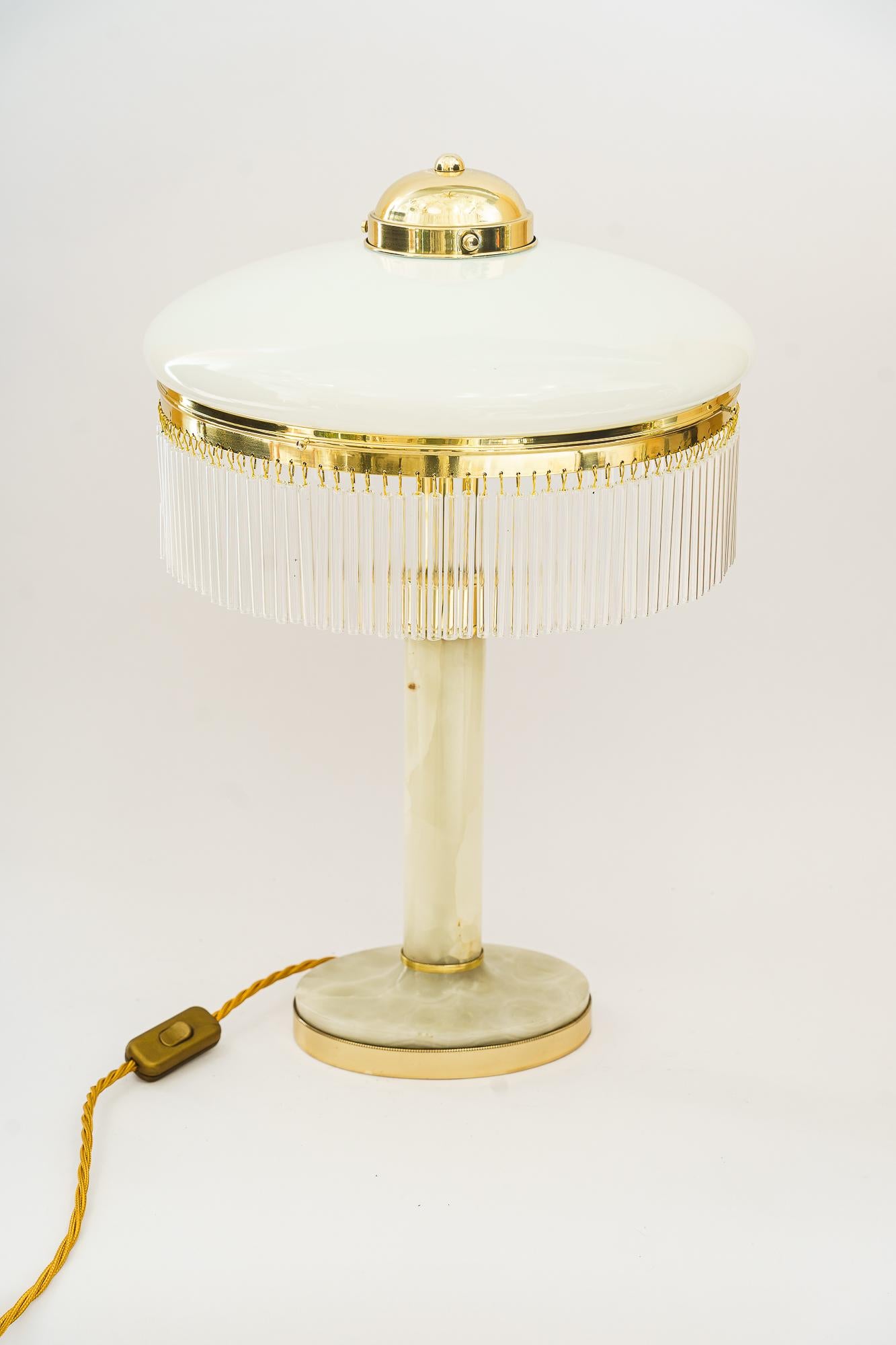 Art Deco Brass and Marble Table lamp with opal glass shade and glass sticks 1920s
Brass polished and stove enameled
Original antique opal glass shade
The glass sticks are replaced ( new )
