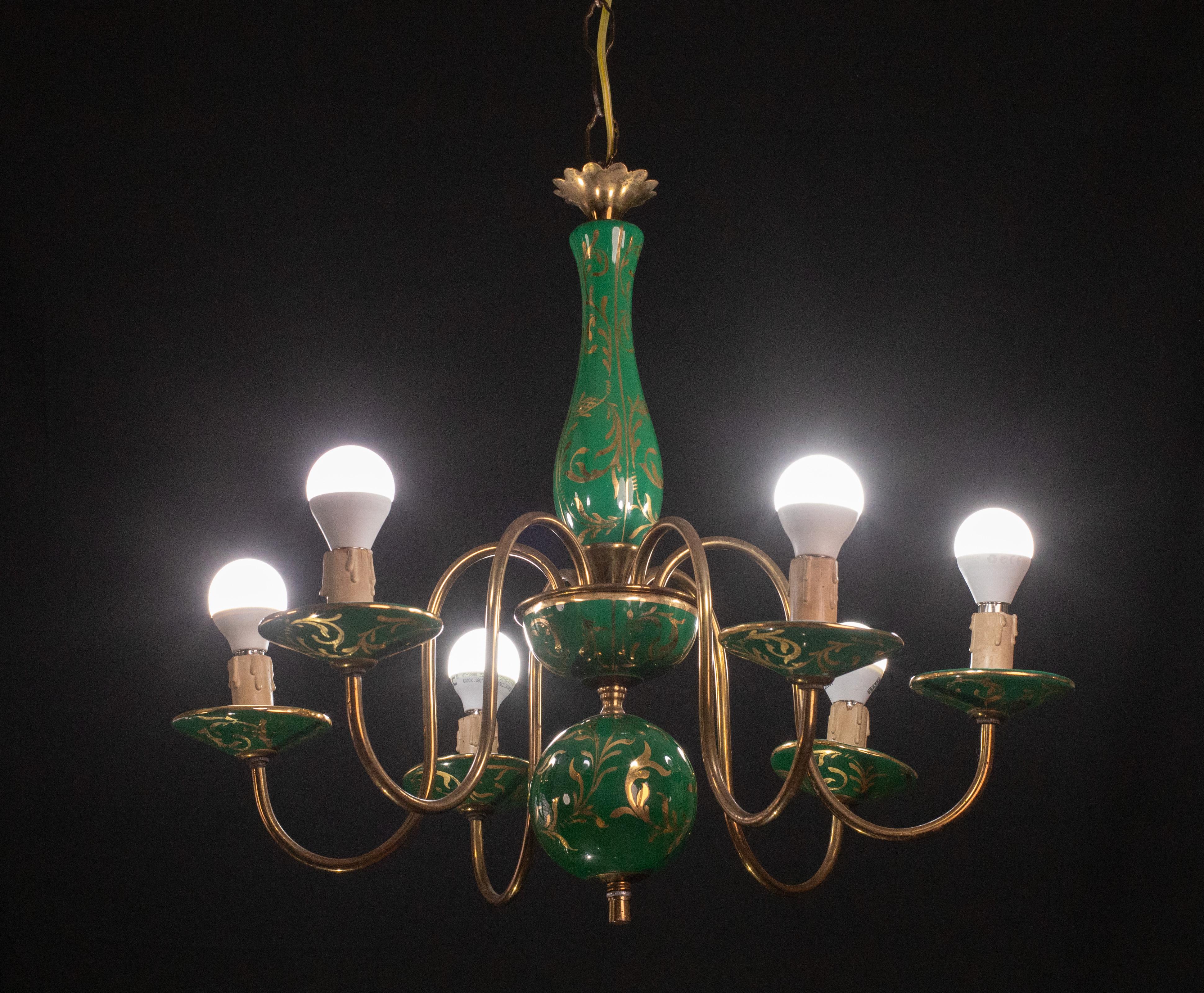 Stunning Art Deco chandelier made of brass and painted terracotta with decorations.

The 6 light points mount a European standard e 14 socket.

Height 120cm, 50 cm without chain, diameter 55 centimeter.

