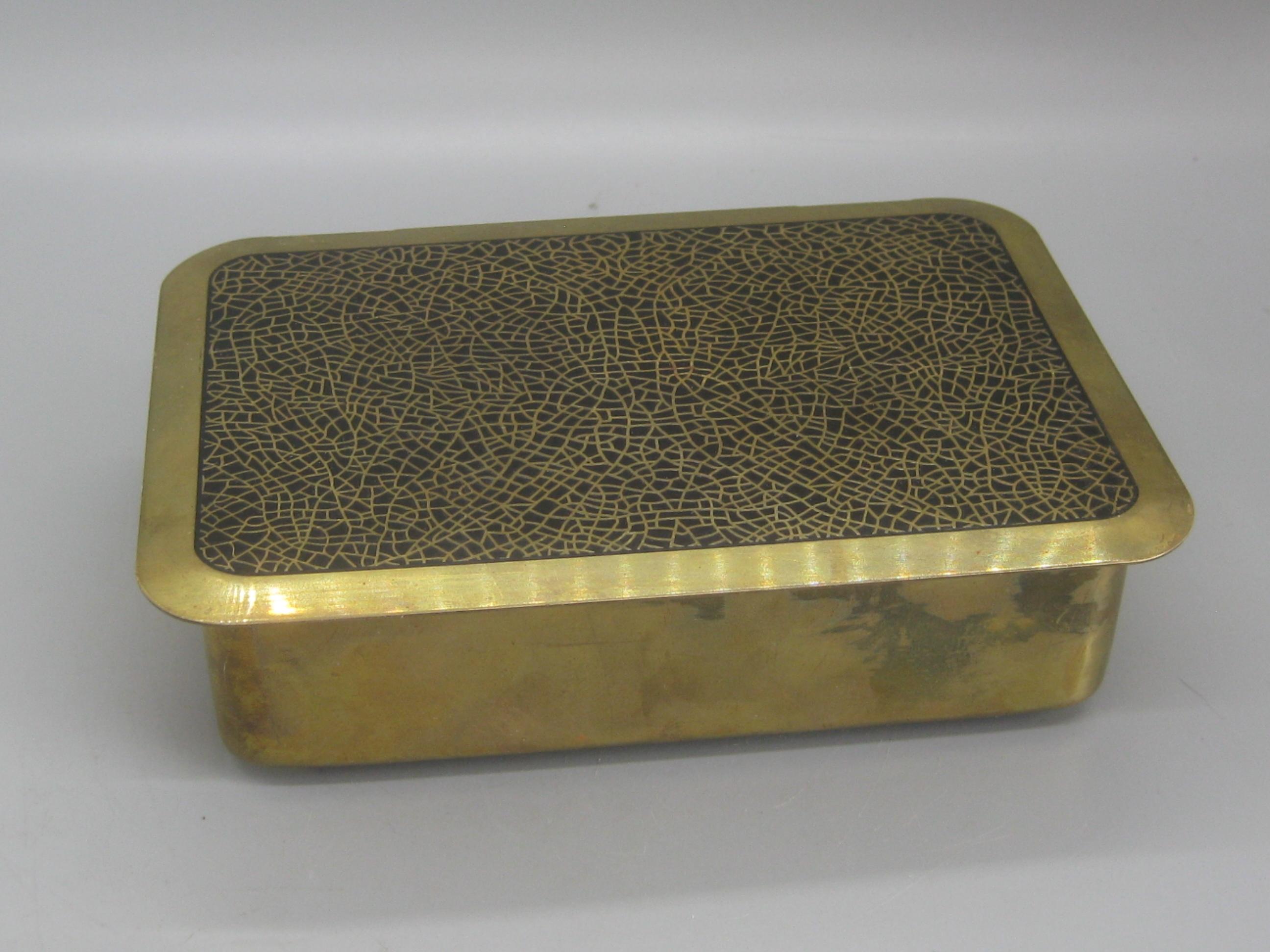 Beautiful Art Deco brass and black enamel desk stash/jewelry trinket box. Top has a wonderful crackle pattern with black enamel inlay. Made of brass and has wooden inserts. Brass has a wonderful patina and can be polished if desired. The top design
