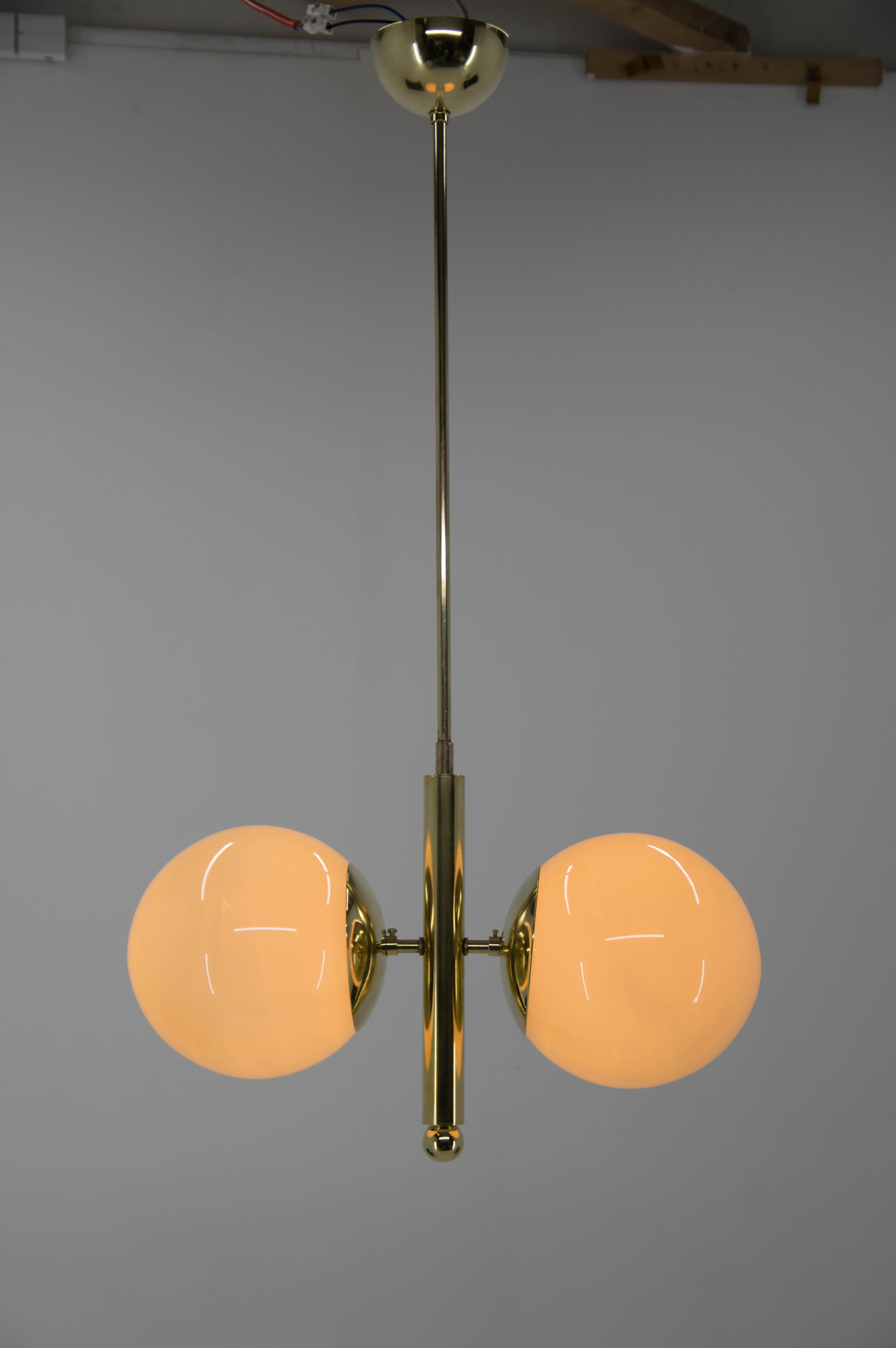 Elegant Art Deco chandelier attributed to Halabala was completely restored - excellent condition
White globes on request.
Rewired: 2x60W, E25-E27 bulbs
US wiring compatible.