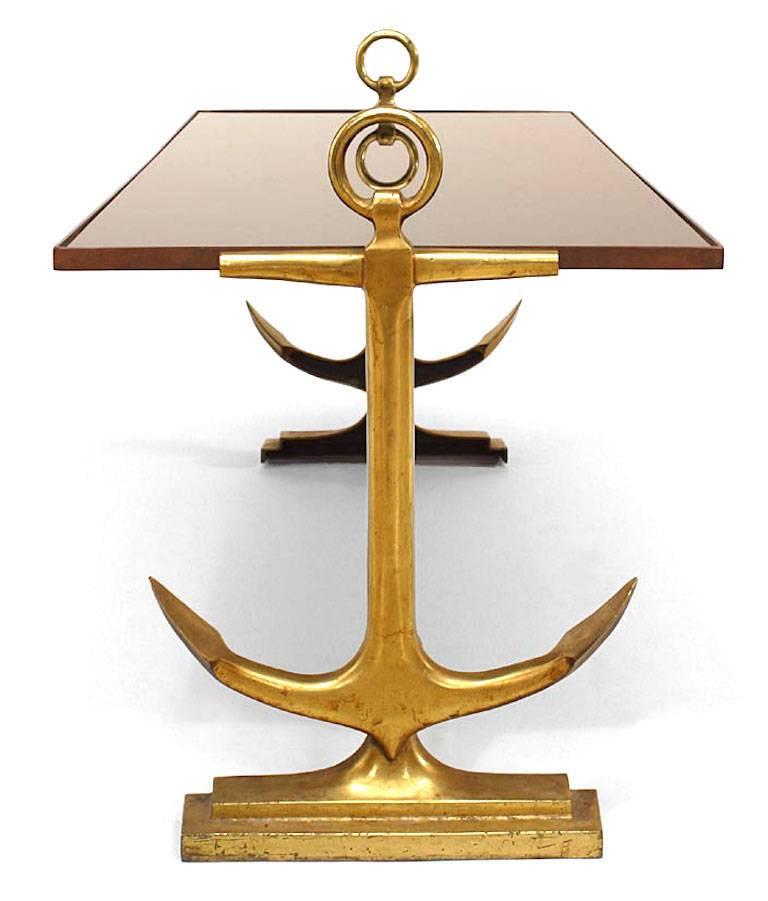 Art Deco brass coffee table with anchor sides and black glass top.
  