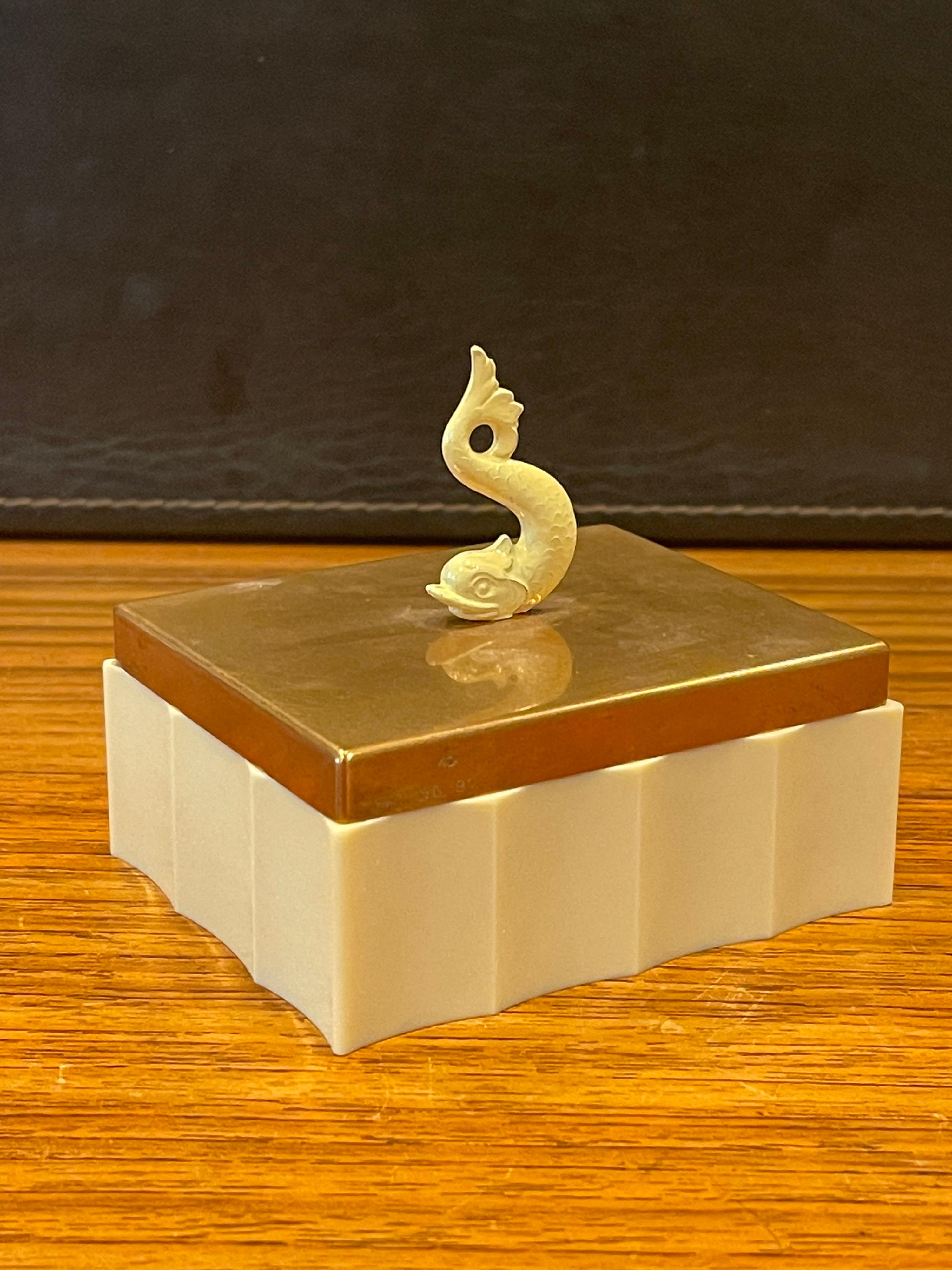 A very cool ivory colored bakelite and copper Art Deco trinket box with a dolphin handle by Chase & Co., circa 1930s. The box is in very good vintage condition and measures 4