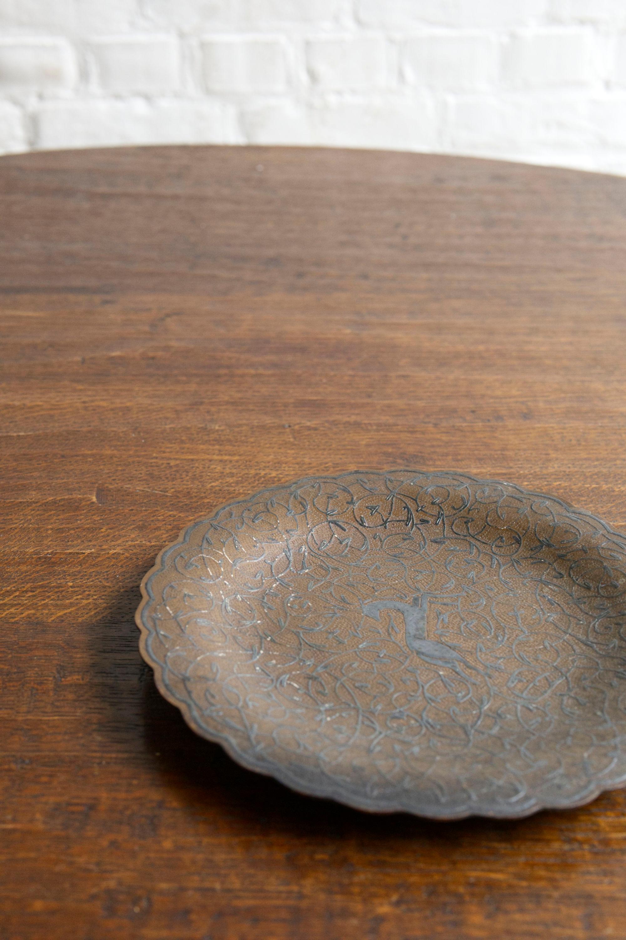 This elegant Art Deco dish from 1930s France features a beautifully etched deer motif at its center, surrounded by intricate elegant linework characteristic of the period. Crafted from brass or copper, the dish showcases fine detailing and skilled