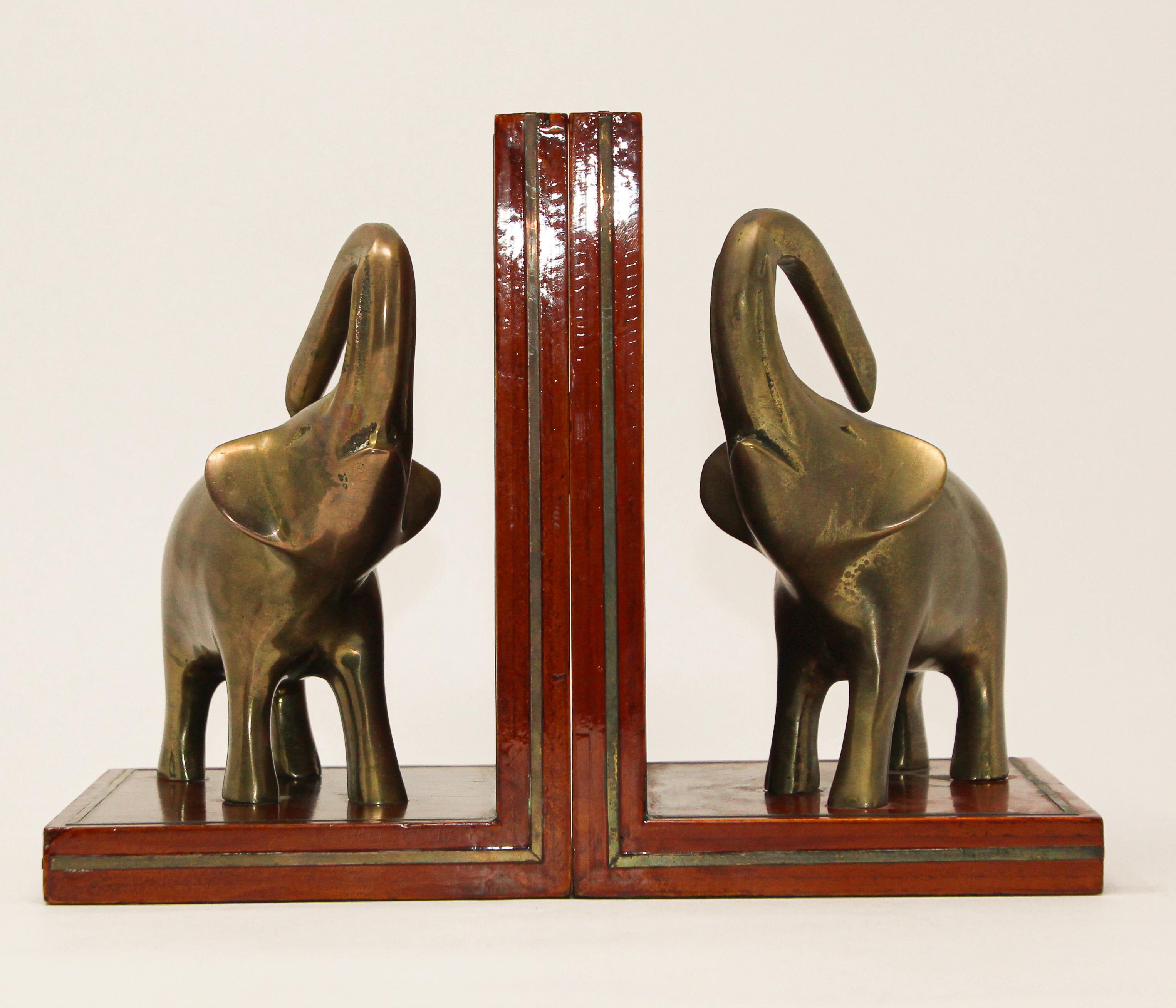 Art Deco style pair of polished brass elephant bookends.
Vintage stylish bookshelf decor elephant’s bookends animal sculpture on wood,
circa 1950
Elephant with trunk up are good luck.
Each book end is: 5