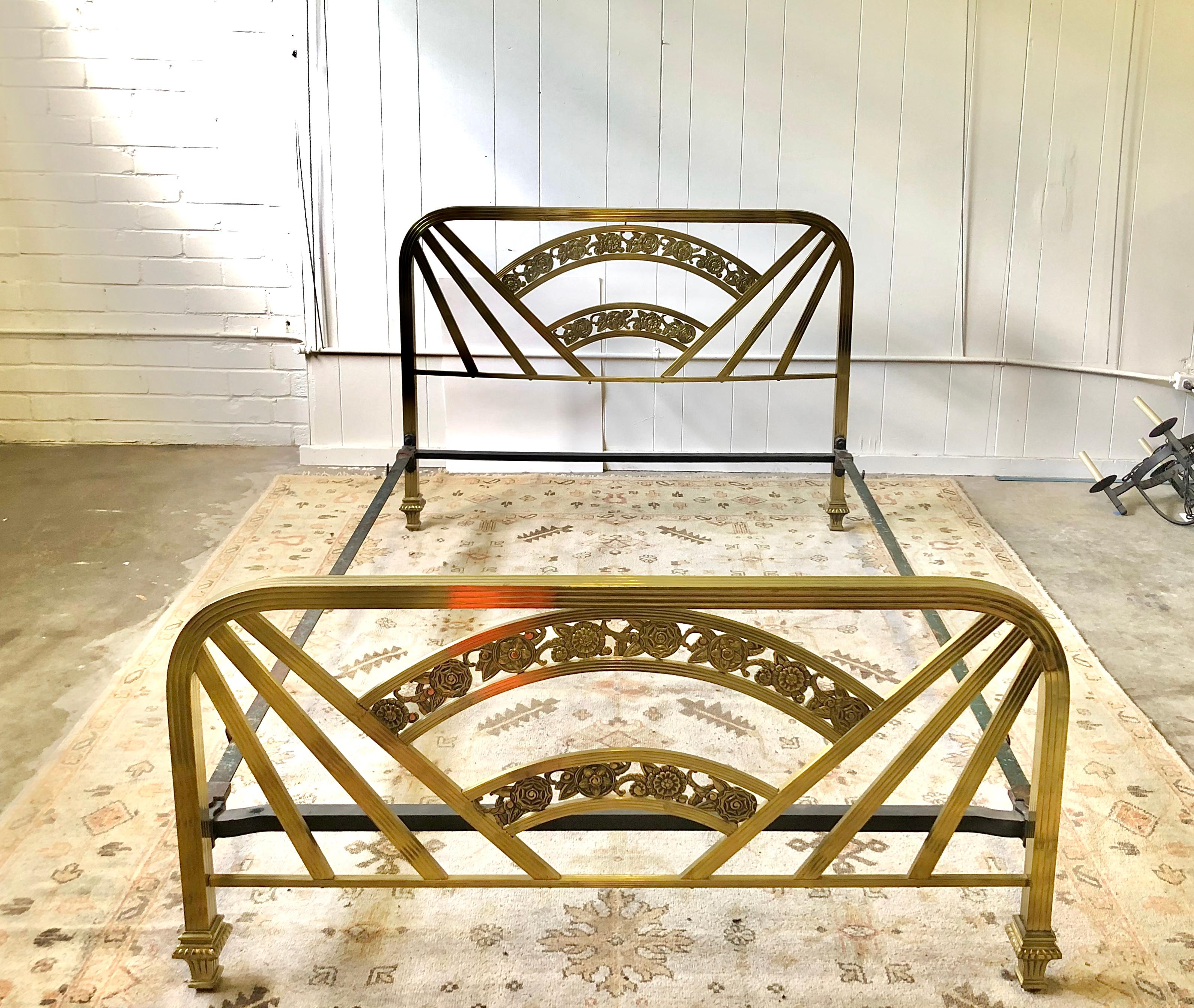 Early 20th century Art Deco full size bed frame with decorative headboard and footboard of brass and including the original side rails. The frame measures: 53.5