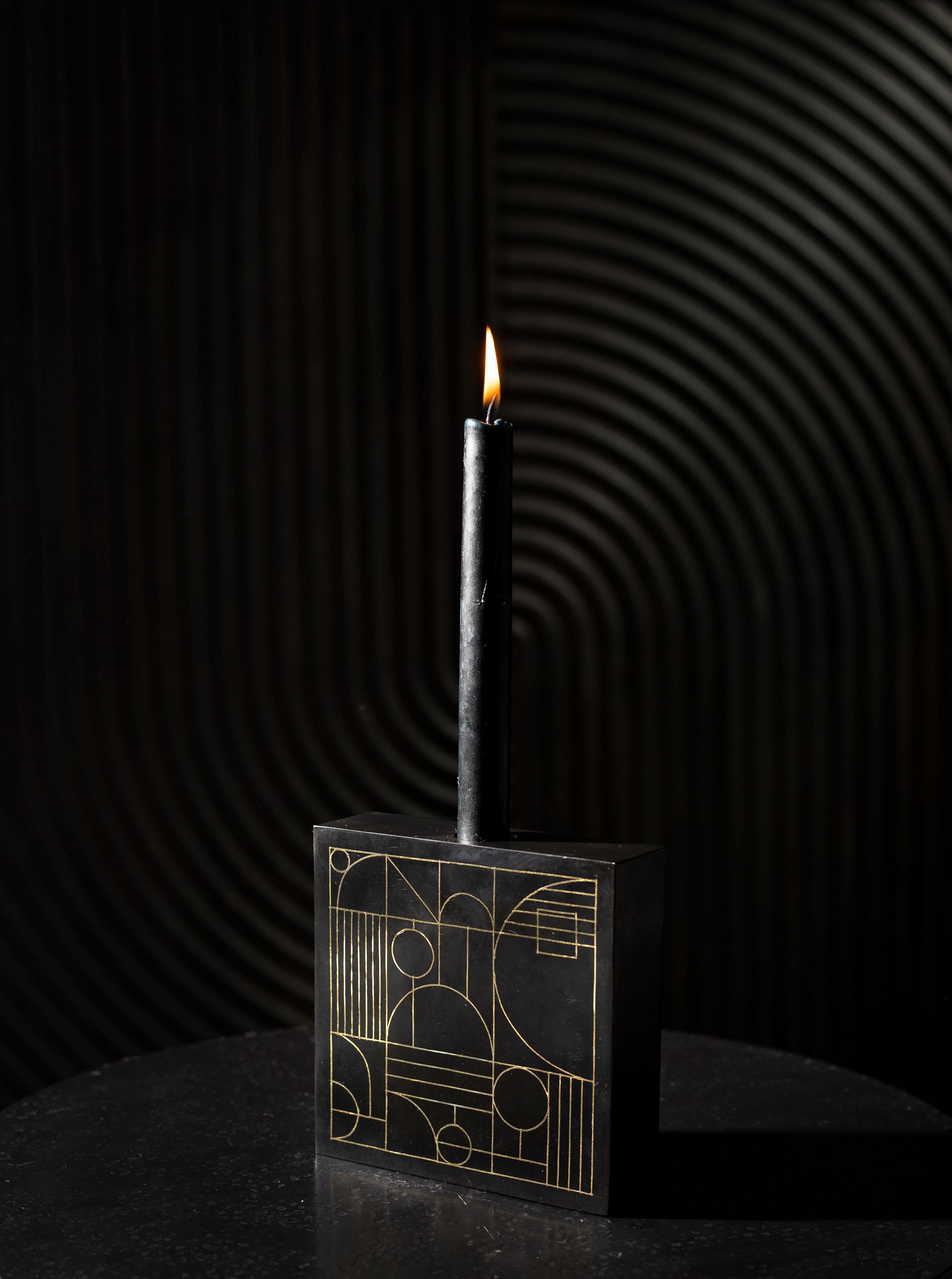 Our Art Deco-inspired candleholders are ethically handcrafted by artisans in Southern India using a technique that is native to the region. The artisans use a metal alloy that is blackened with a locally found soil, and the piece is inlaid with
