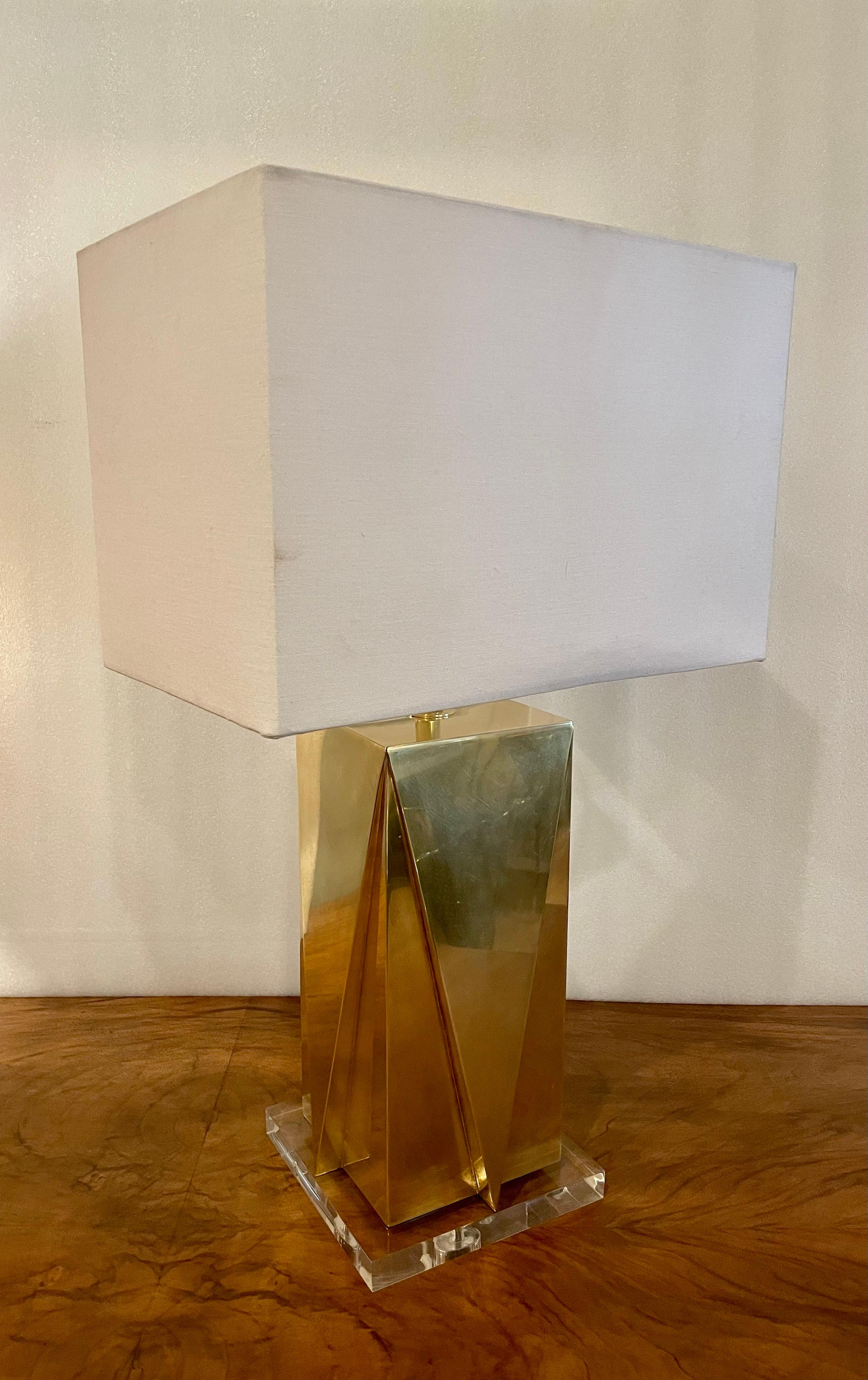 Striking beautiful polished brass table lamp sitting on a solid lucite base, circa 1960s freshly rewired, and polished we put a new lampshade, 16