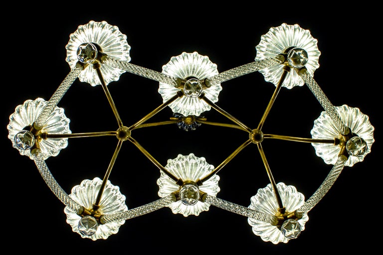 Exceptional eight -shade Murano glass chandelier with elegant shaped brass mount, by Ercole Barovier .
Excellent vintage condition.
Eight E 27 light bulbs compatible with US standards.