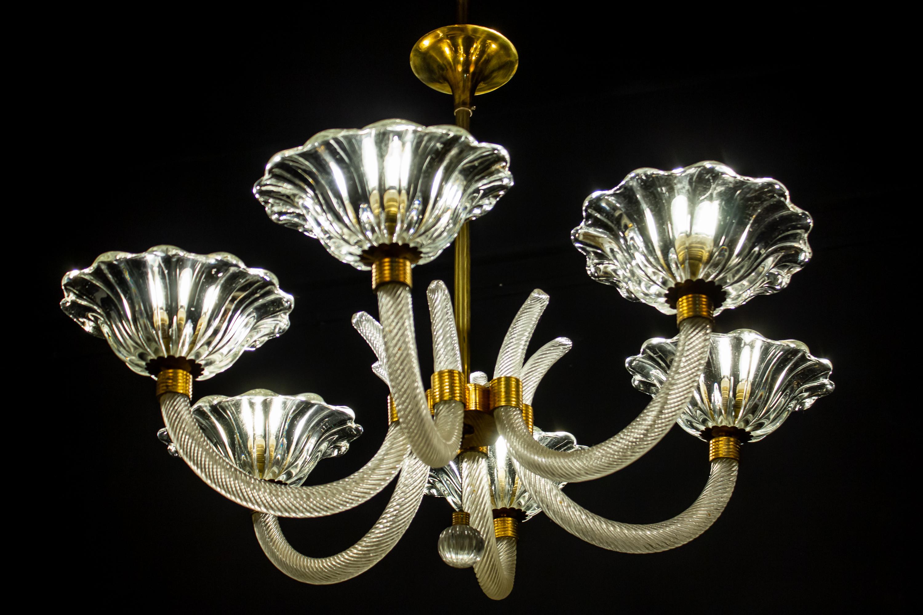 Exceptional six-shade Murano glass chandelier with elegant shaped brass mount, by Ercole Barovier.
Excellent vintage condition, the glasses are in perfect condition.
Six E 27 light bulbs compatible with US standards.