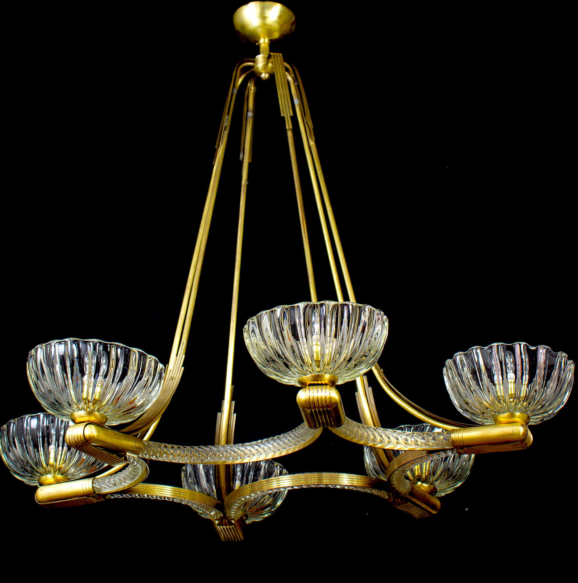 Exceptional six -shade Murano glass chandelier with elegant shaped brass mount, by Ercole Barovier.
Excellent vintage condition.
Six E 27 light bulbs compatible with US standards.