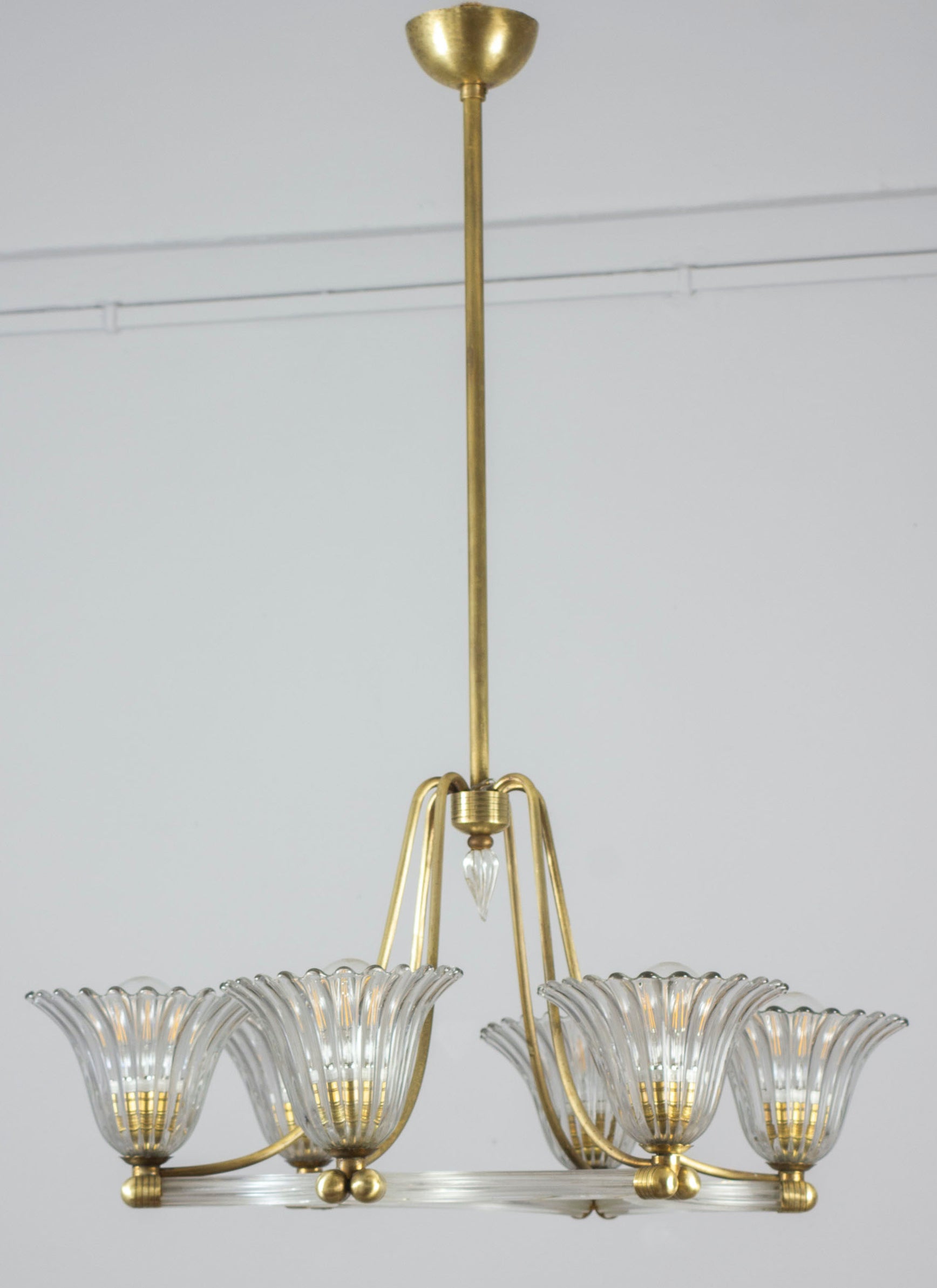 Exceptional six-shade Murano glass chandelier with elegant shaped brass mount, by Ercole Barovier.
Excellent vintage condition.
Six E 27 light bulbs compatible with US standards.
 The height of the brass rod can be shortened on request.
Cleaned and