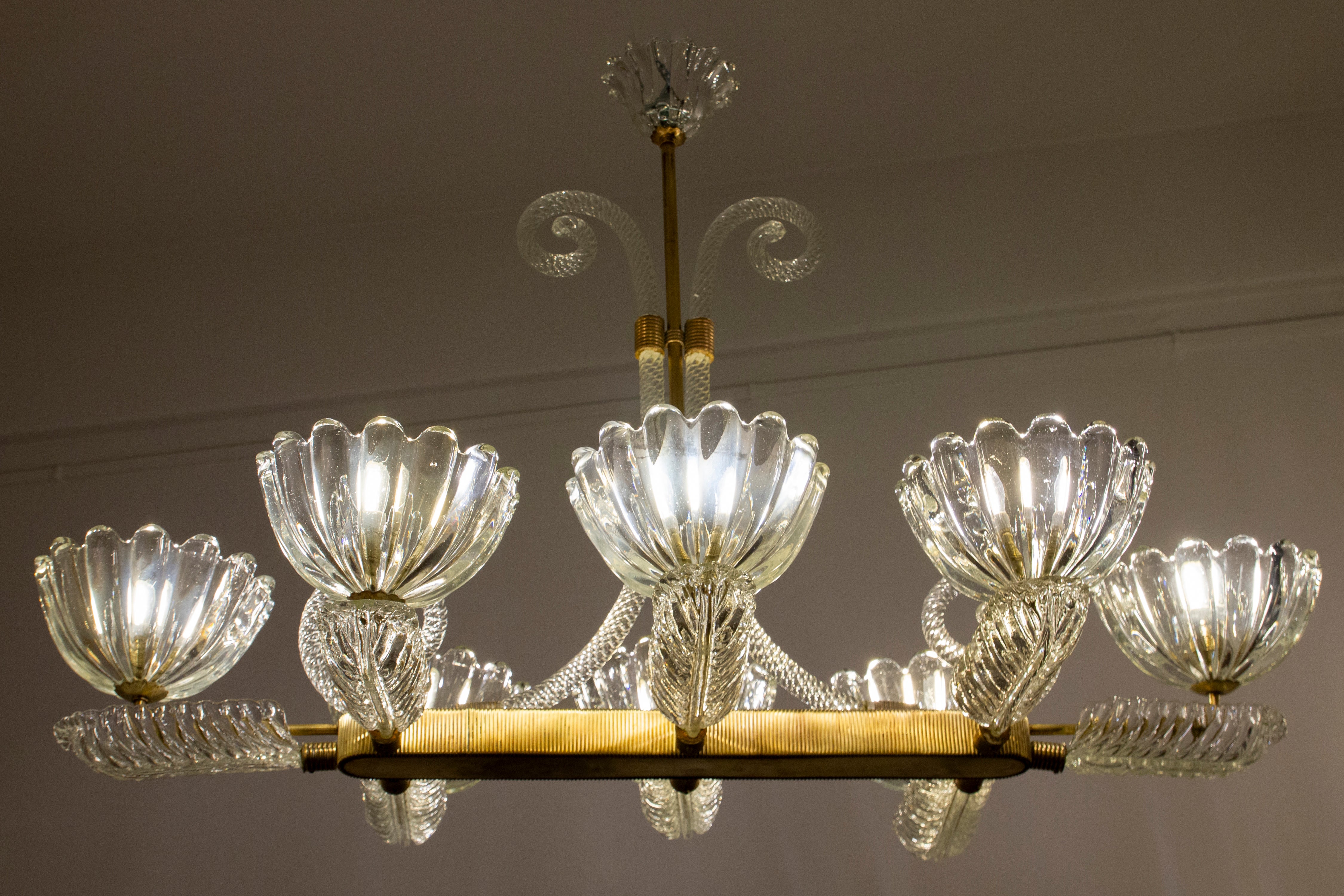 Sensational eight shade Murano glass chandelier with elegant rectangular shaped brass mount, by Ercole Barovier.
Excellent vintage condition.
Eight E 27 light bulbs compatible with US standards.
Cleaned and re-wired, in full working order and ready