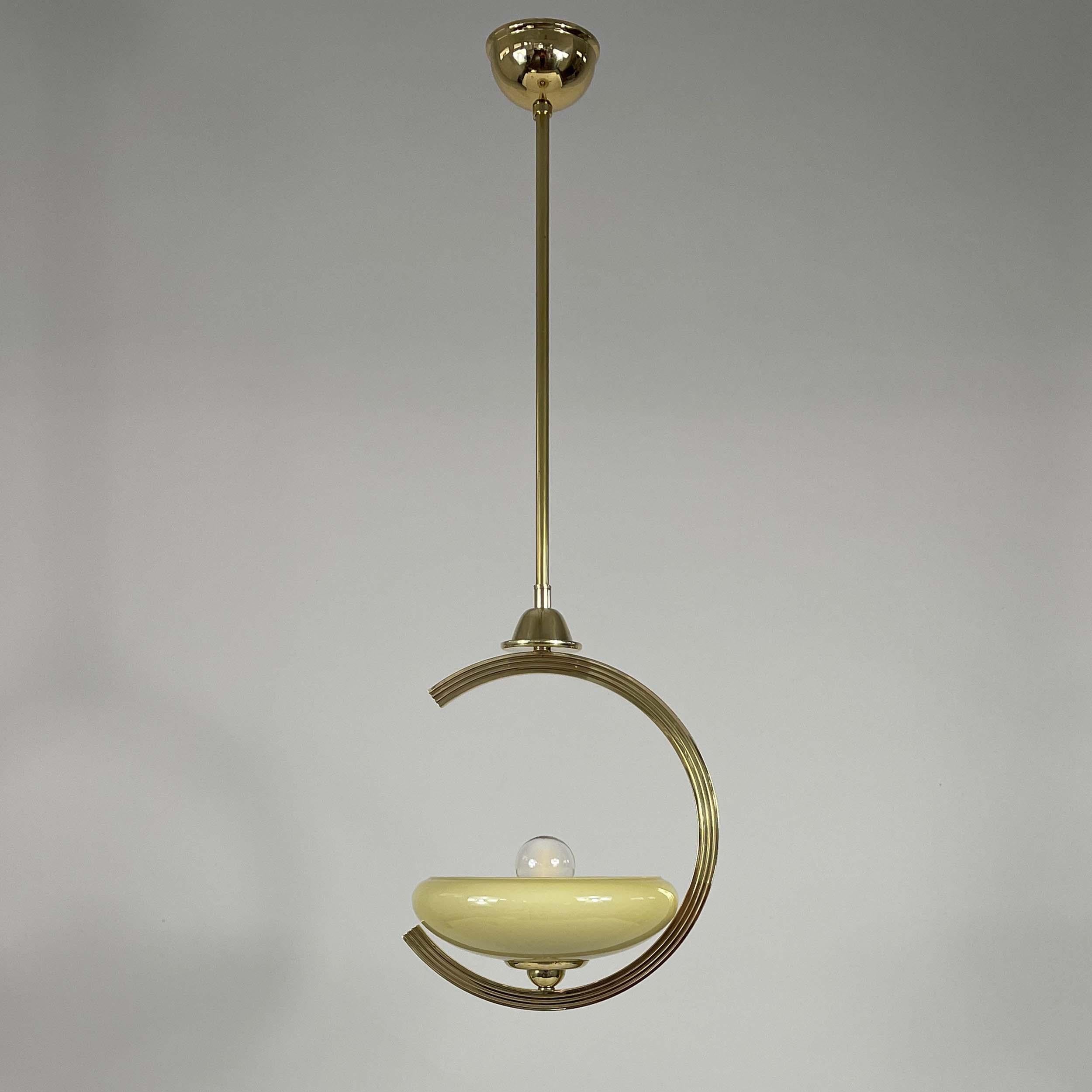 This pendant light was designed and manufactured in Sweden in the 1940s. It features a dark cream / sand colored opaline lampshade and brass hardware.

Measurements:
Total height 30