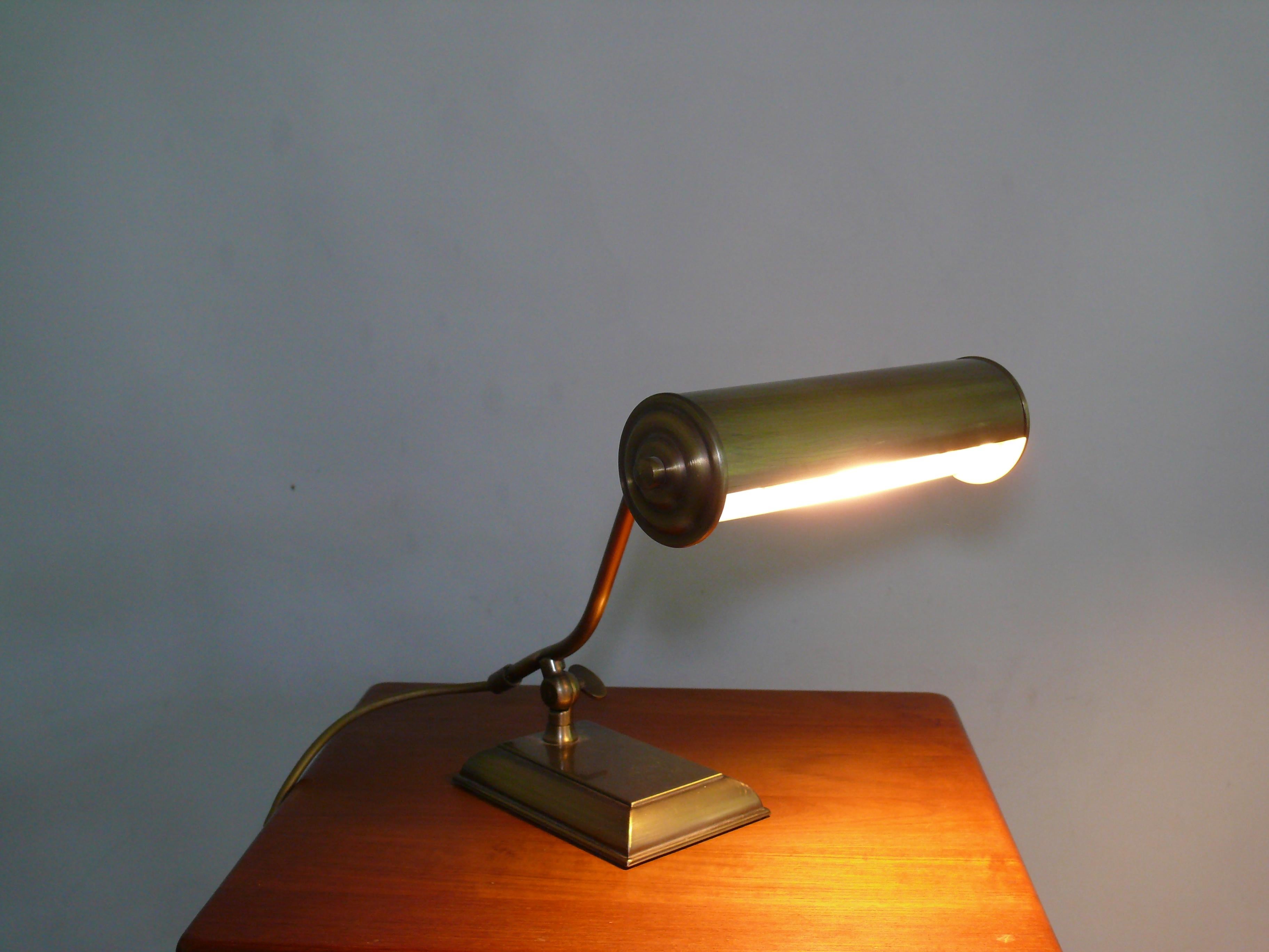 Very solid piano lamp made of brass, West Germany, approx. 1970s - 1980s from the Sölken company, model 2535-011. The lamp is made of burnished brass. The shade can be adjusted using a ball joint. Another adjusting screw is located on the foot. The
