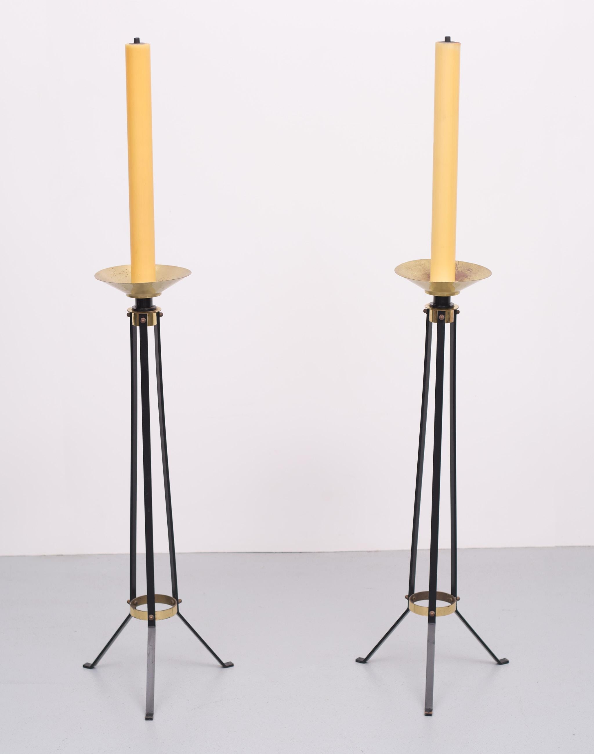 Two very nice elegant Art Deco Church torchères. Black Metal tripod frame, comes with Brass Details.
 The height measurements are without the candles 90 cm high
with the candles 136 cm.
