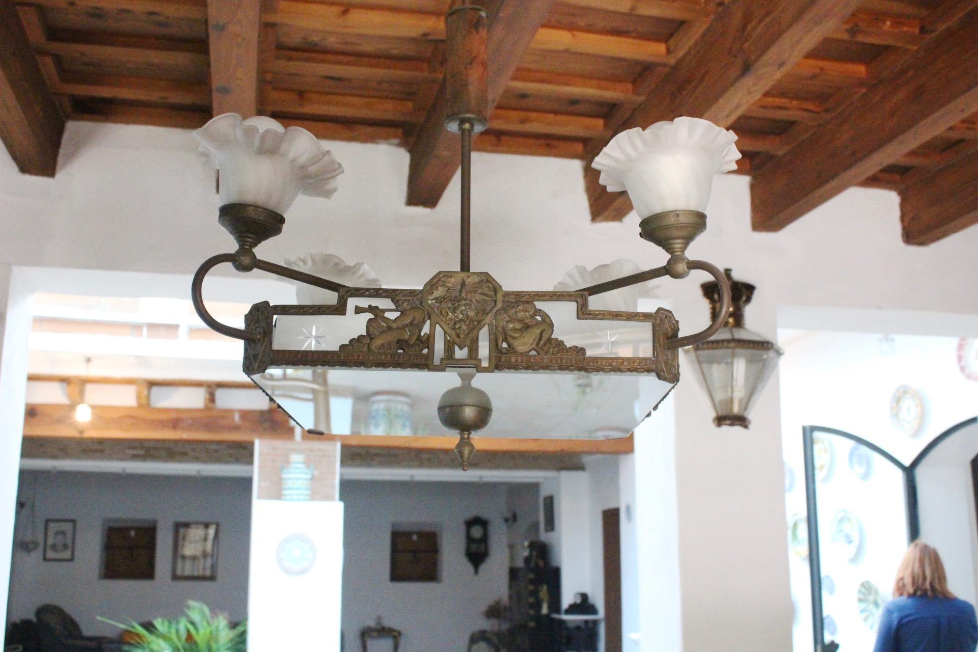Art Deco brass and white glass chandelier, Spain, 1930s.
- Stem, with a piece of wood.
- Acid and hand etched glass shades,
- Patina all over the brass. Can be removed under request.
Note: Piece belong to a personal collector who is selling the