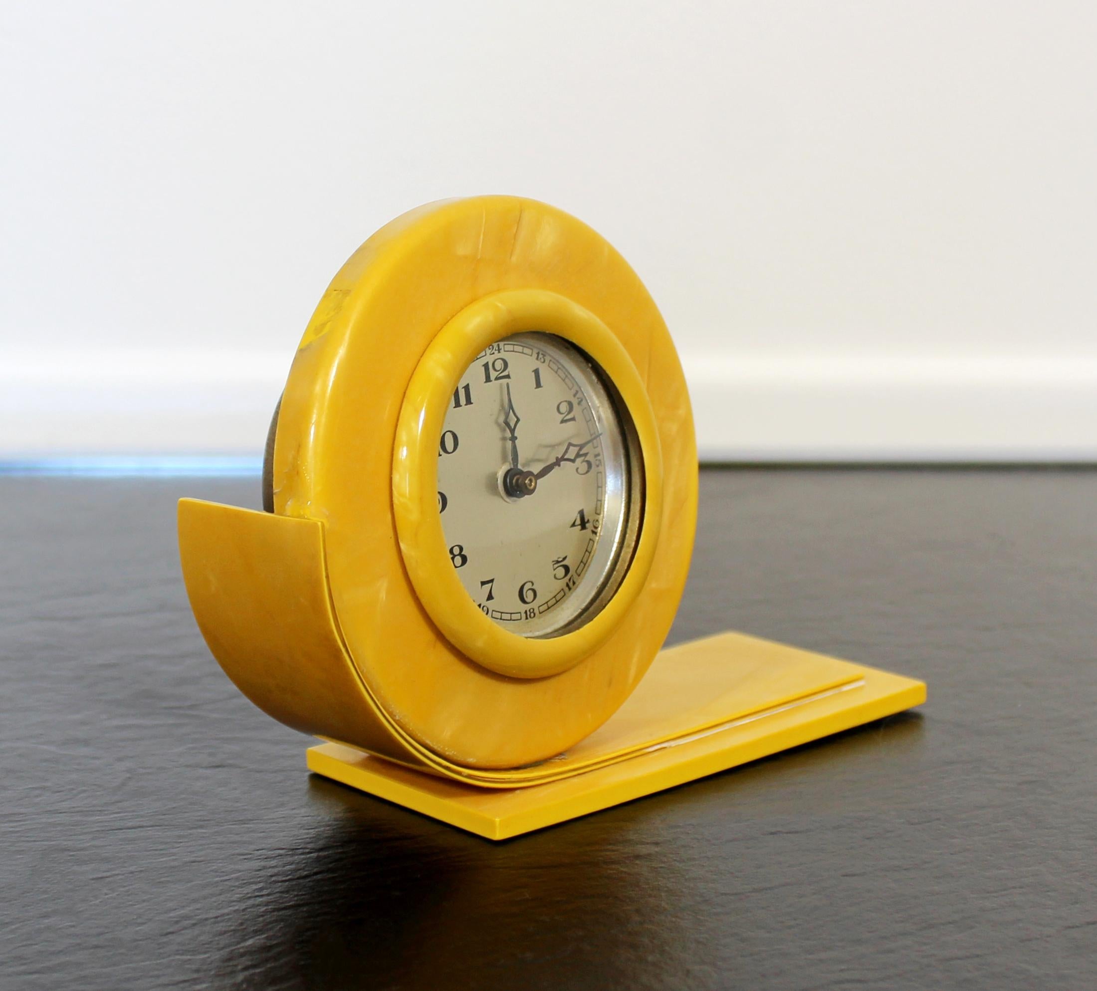 For your consideration is a small but vibrant, yellow celluloid mantle or shelf clock, made in England, circa the 1930s-1940s. In very good antique condition. The dimensions are 5.5