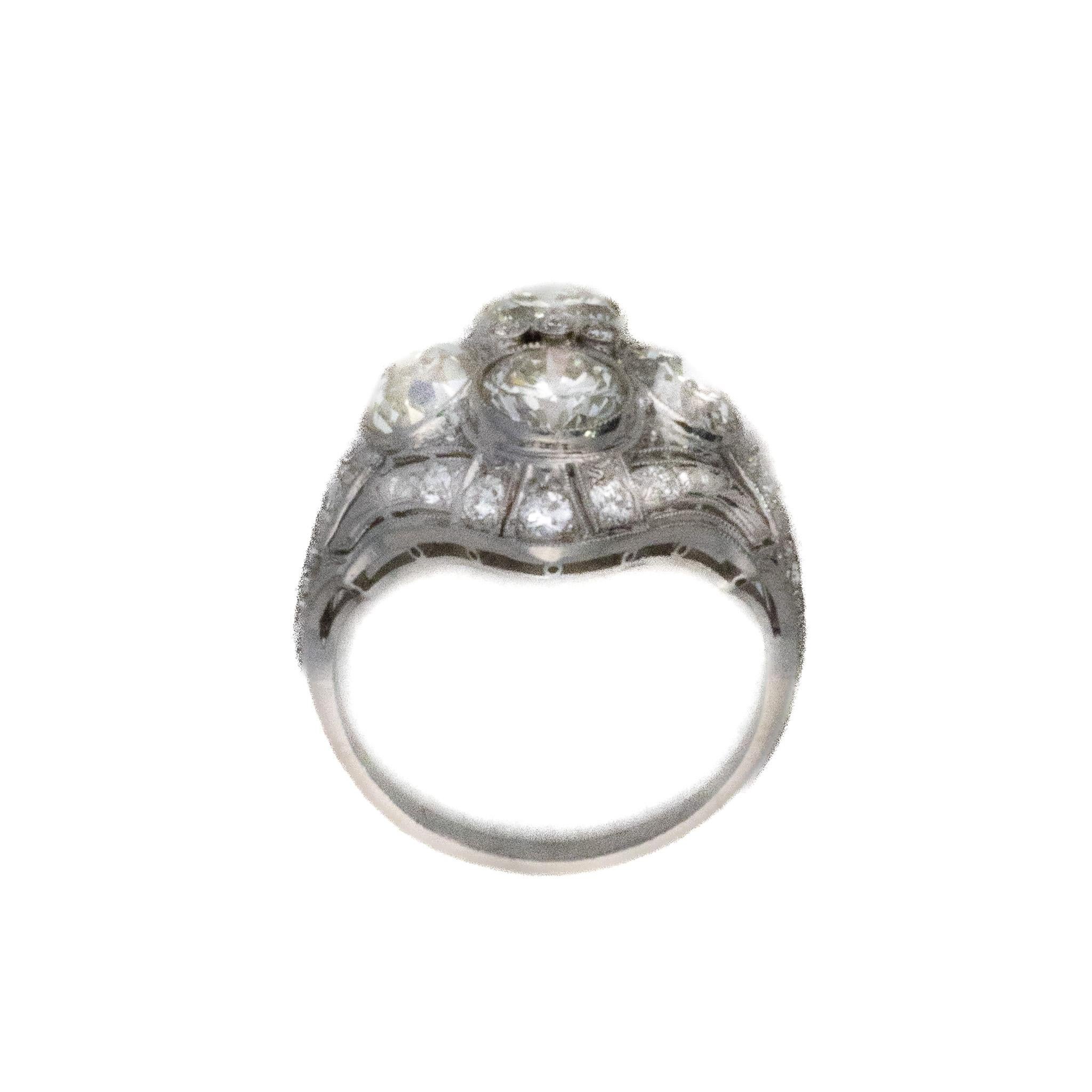 Art Deco Brilliant Cut Diamond Ring

Description: This 18K white gold ring showcases a softly contoured diamond cluster design centered around a bright round diamond, framed by three additional round diamonds that create a balanced, sculptural