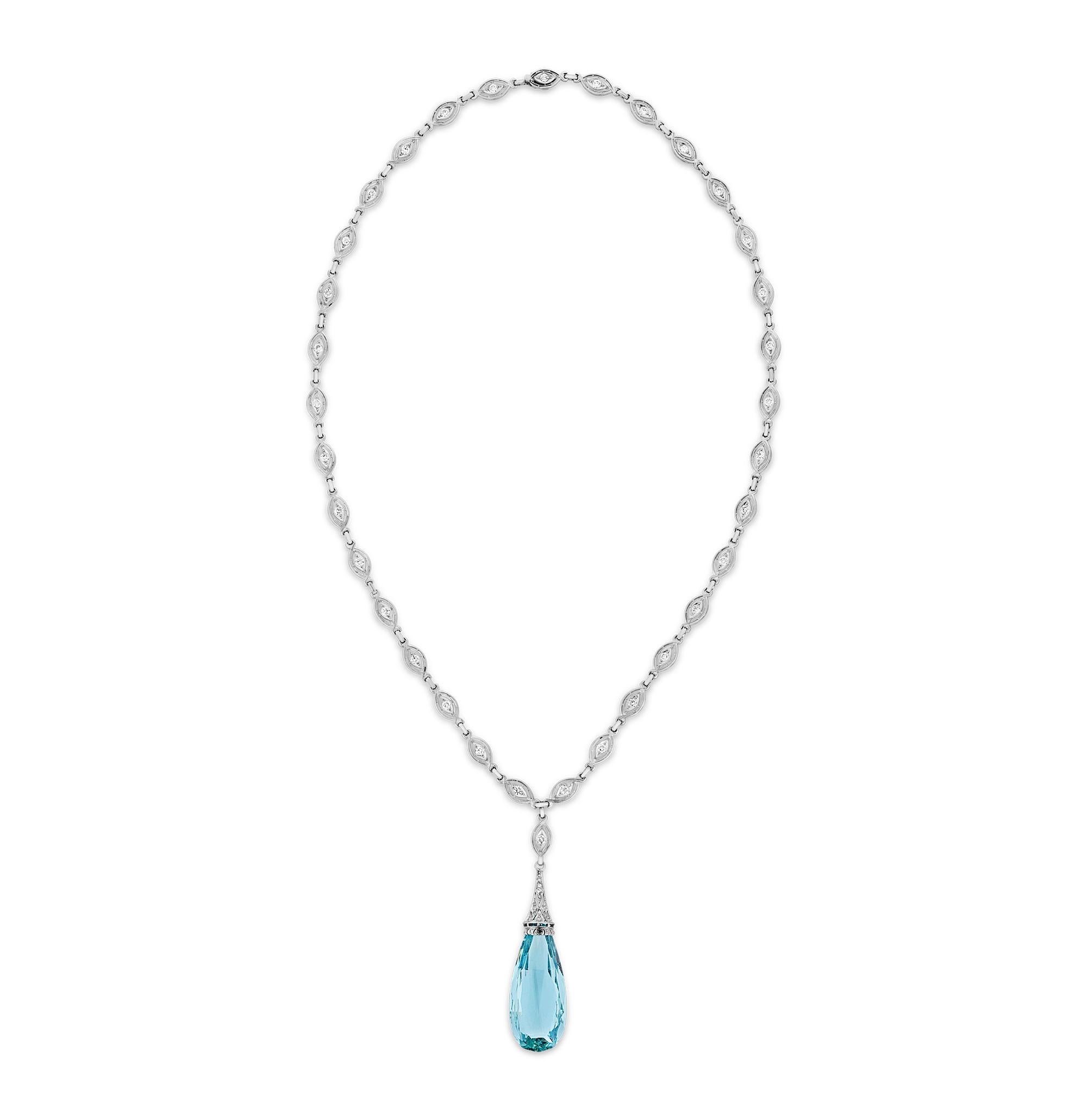 This breathtaking Art Deco necklace showcases a magnificent 40.00-carat briolette cut aquamarine, exuding a striking clarity and oceanic hue. Suspended from an ornate chased platinum chain adorned with 3.00 total carats of round brilliant diamonds,