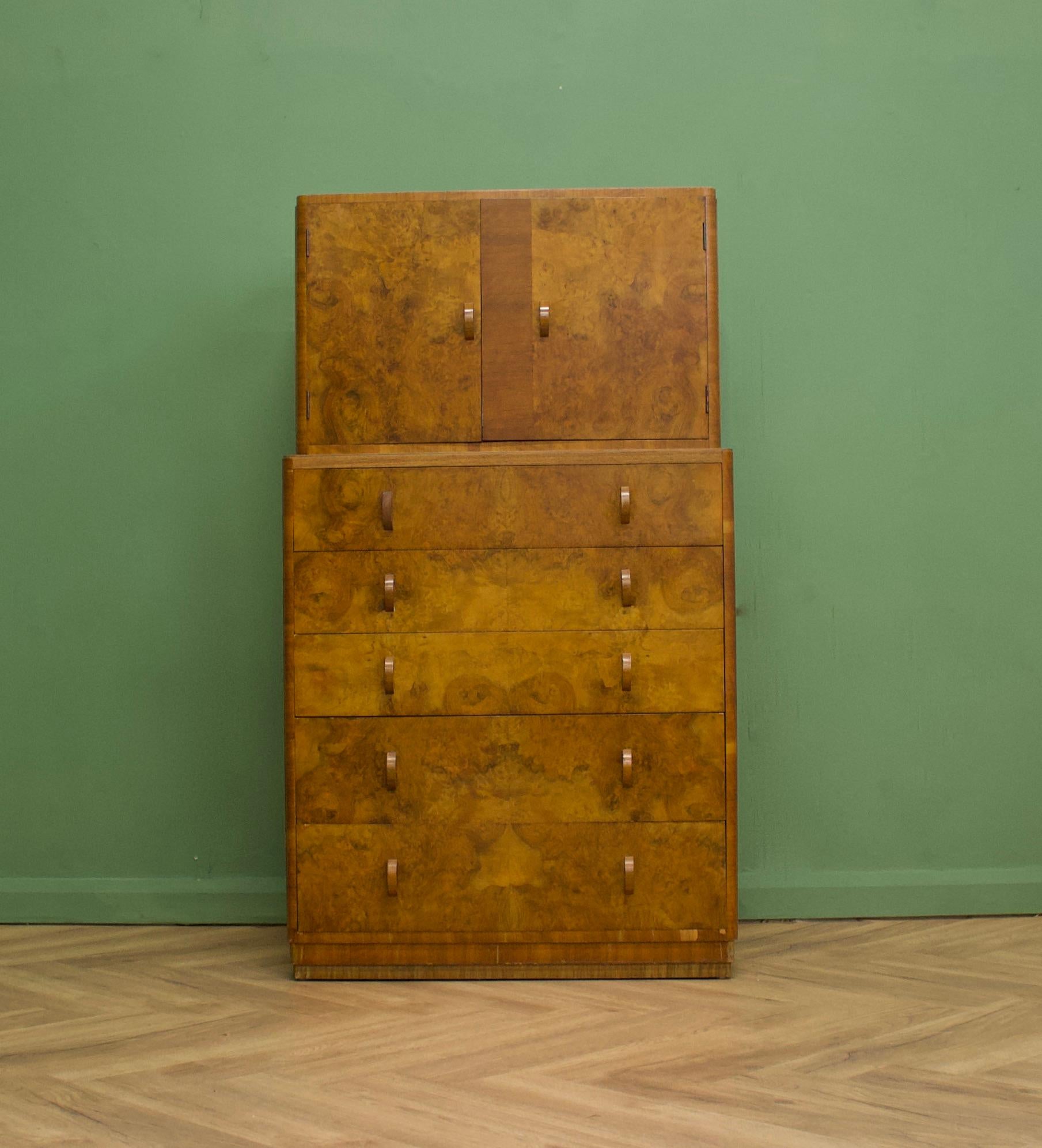 An impressive quality, 1930's burr walnut tallboy from Compactum
There is a cupboard to the top and additionally five drawers