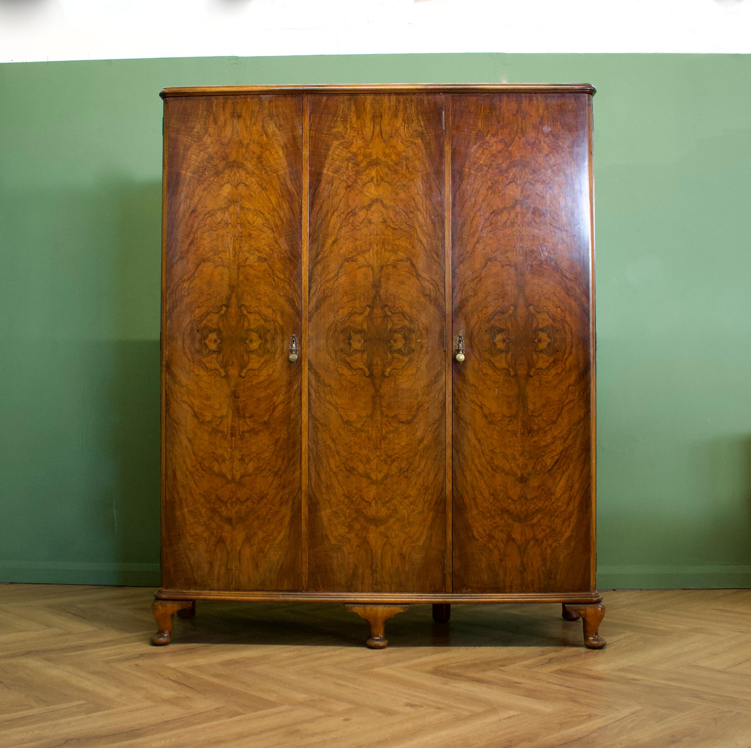An impressive quality, 1930's burr walnut triple door wardrobe - perfect for a maximalist interior
The intense walnut veneers have been beautifully quarter matched on the doors


The interior is beautifully fitted with a hanging rail to the larger