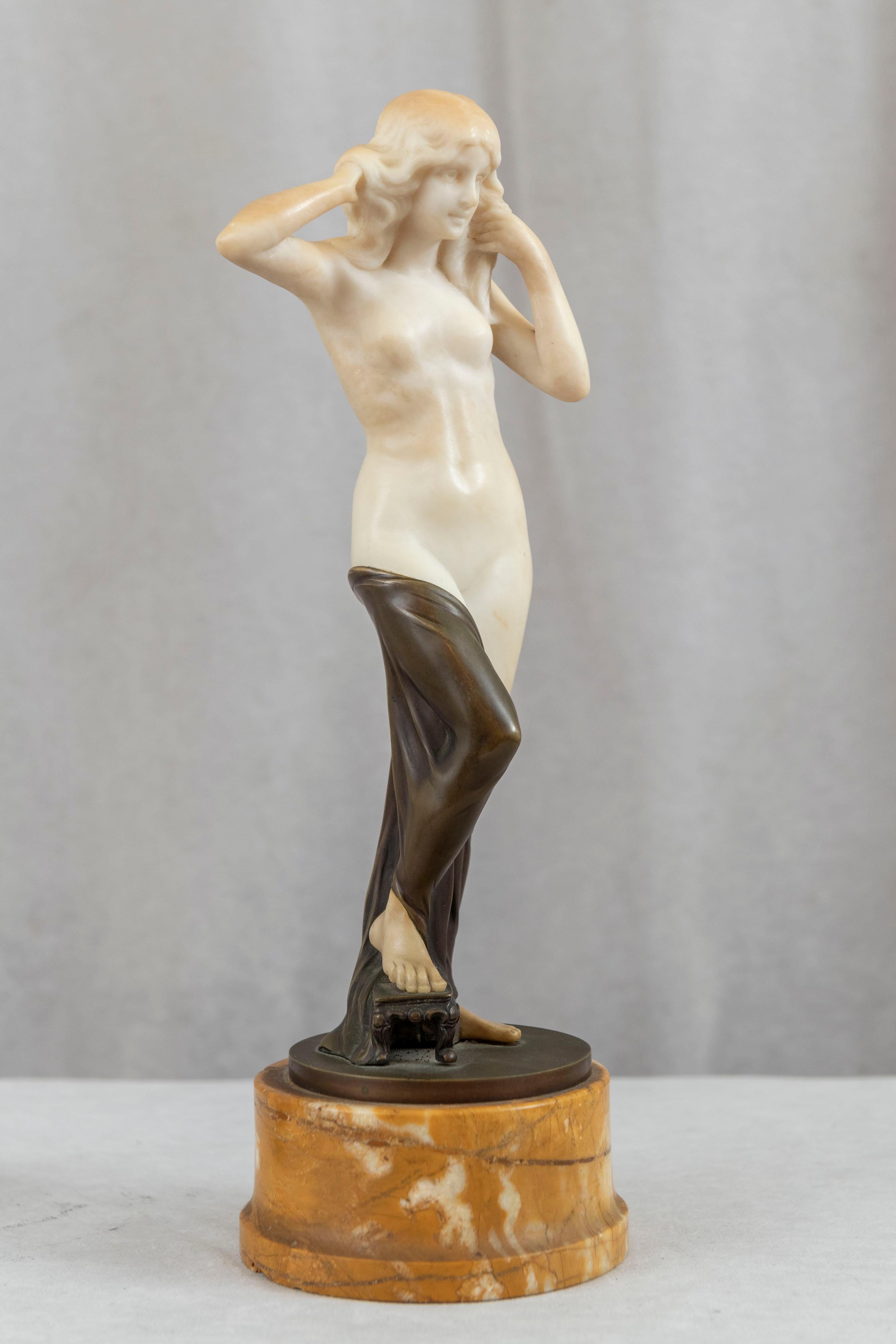 This sexy young nude maiden displays two mediums used to create a sculpture, cast bronze and hand carved alabaster. The white alabaster brings the statue to life, and is a nice addition to any statue of a female. The beautiful nude has flowing hair