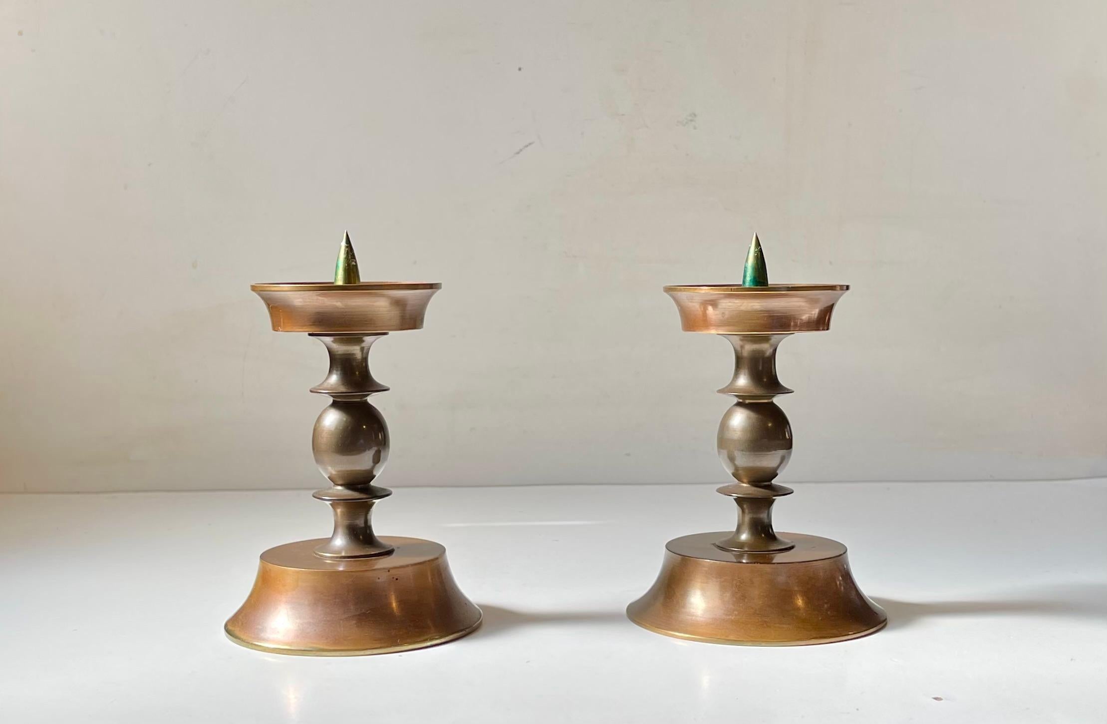 A pair Alter candleholders for Church - Bloc Candles. They are made from solid heavy bronze set with architecturally perceived column centerpieces. A bit of early Brutalism or Gothic revival can be read in to the style of this 1930s pair of