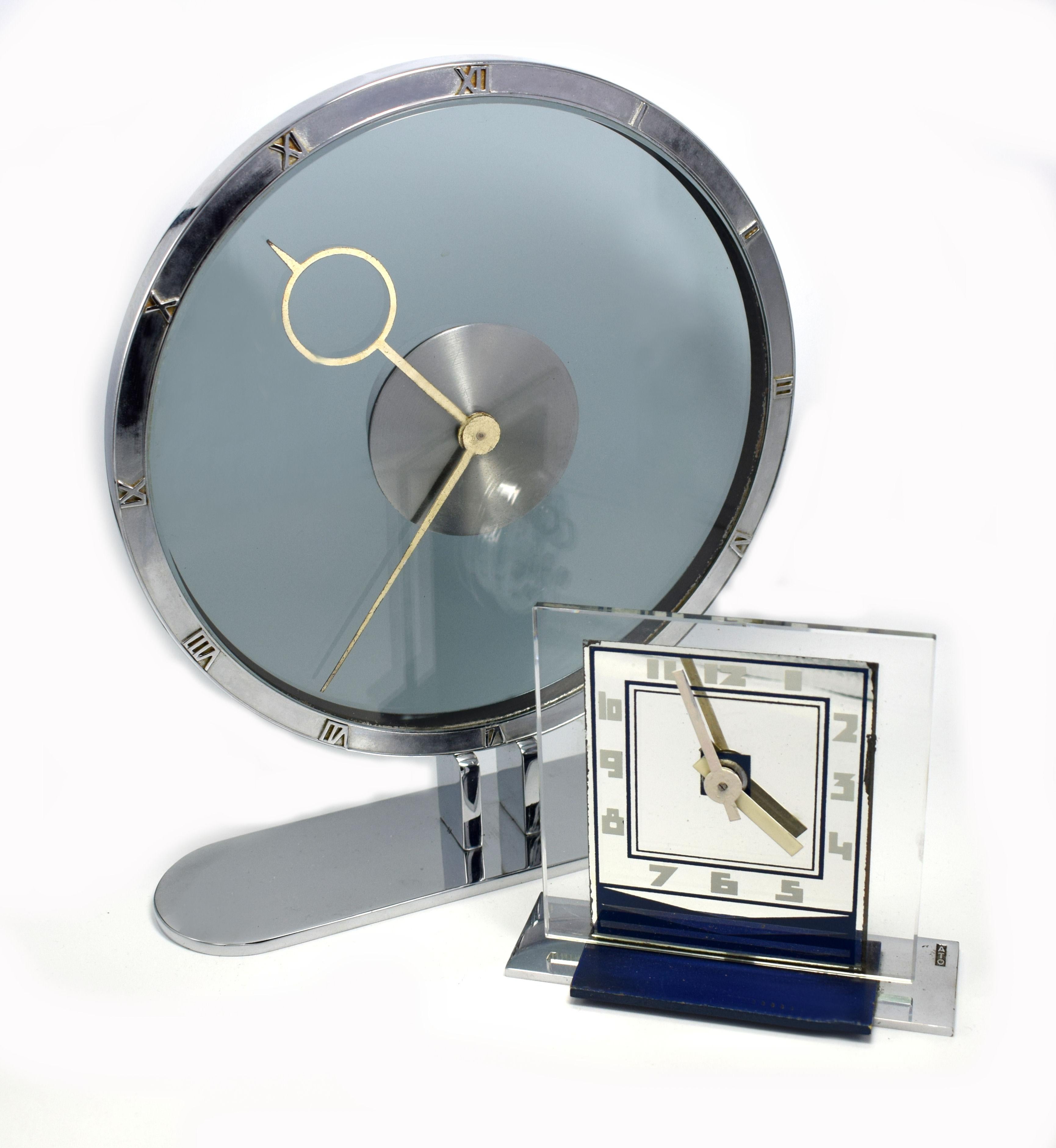 Superbly stylish is this wonderful Art Deco 8 day mystery clock by Kienzel. Beautiful pale blue /grey colored glass and nickel plated desk timepiece, typical of the 1930s and totally authentic. The nickel case is polished and lacquered. The chapter