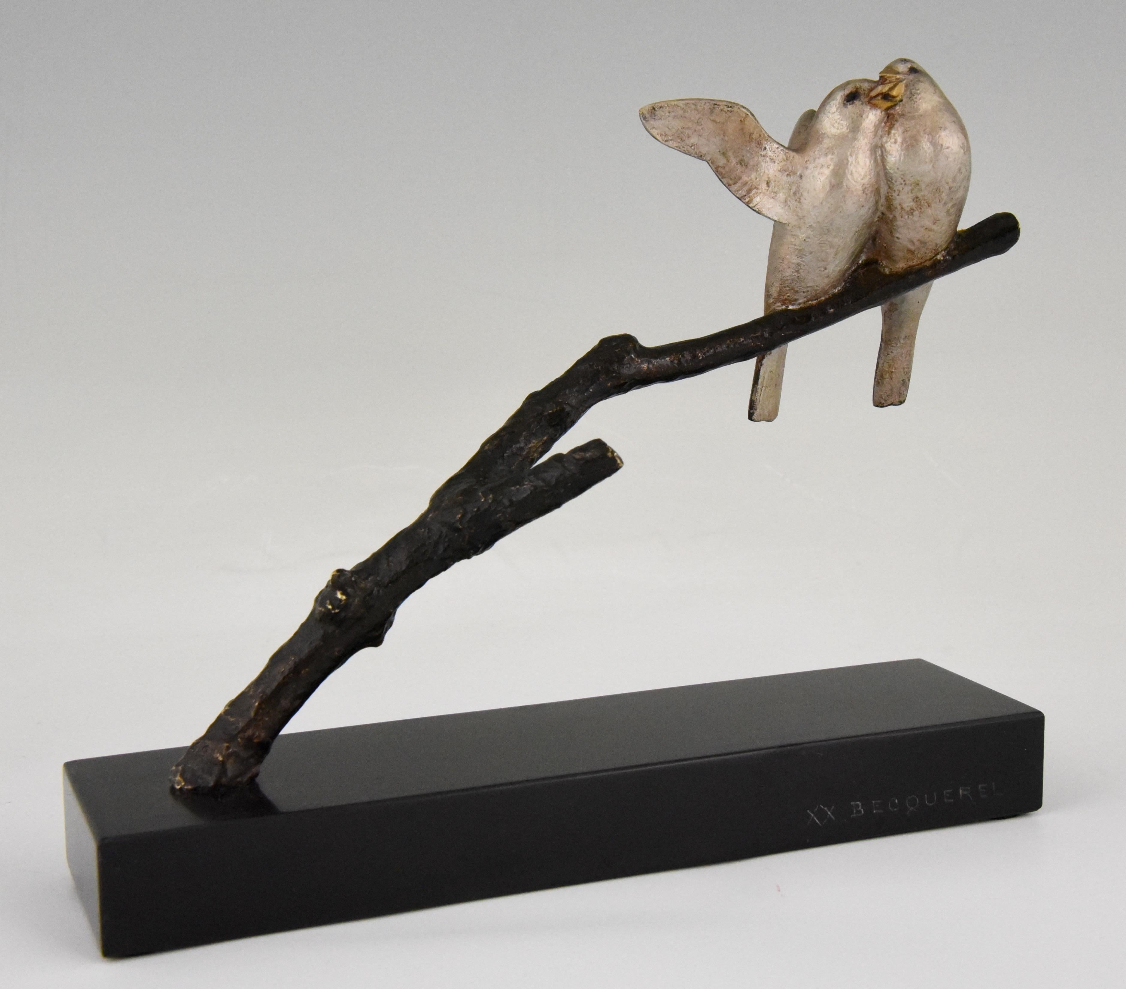 Cute Art Deco sculpture of two birds on a branch by the French sculptor Andre Vincent Becquerel. The patinated bronze stands on a Belgian Black marble base and is signed by the artist. France, circa 1930.
        