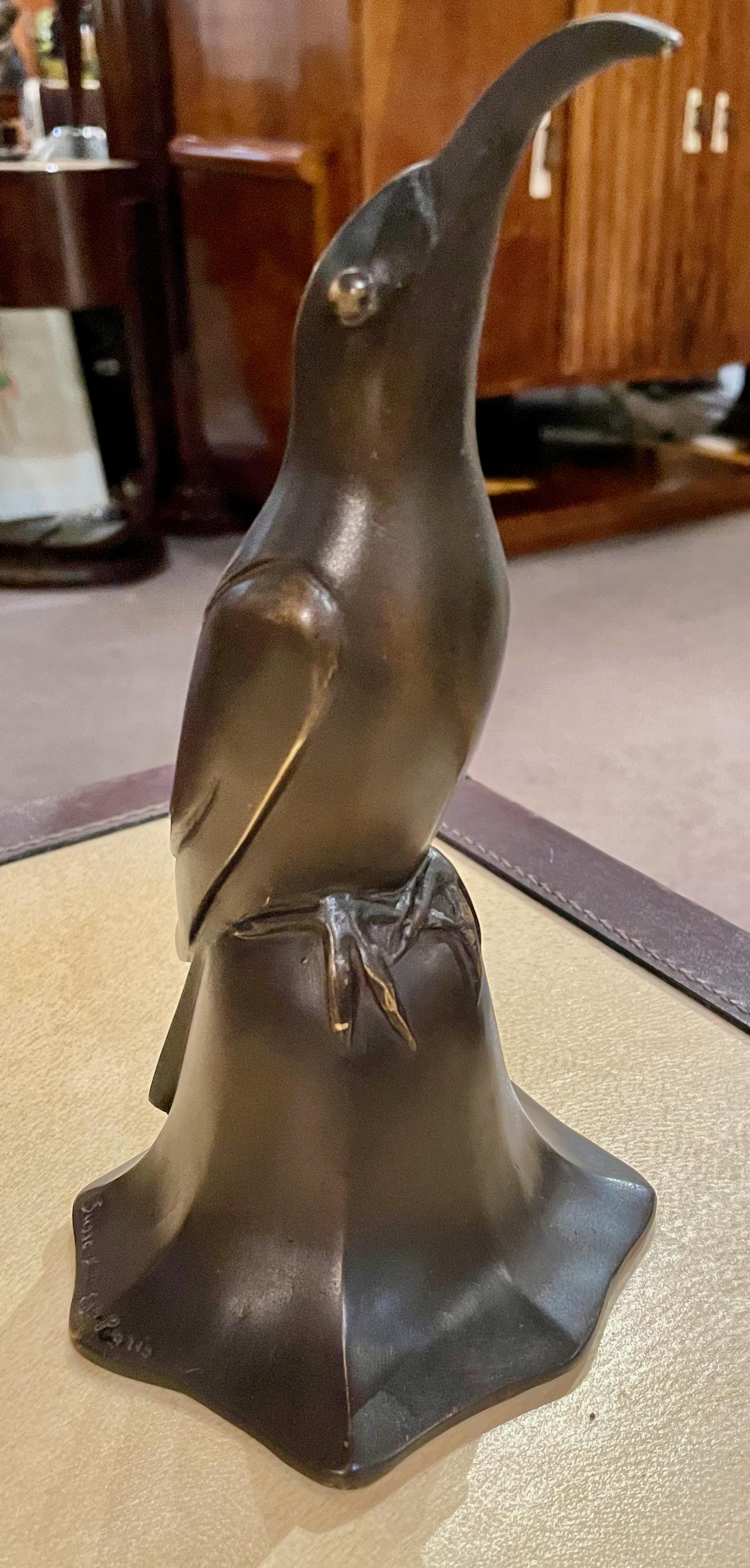 Art Deco bronze blue bird bell sculpture by Edouard Marcel Sandoz. Bronze cubist bird figurine, circa 1920, finished in original dark brown/copper patinated bronze. Signed on the sides of both edges edge, E.M. Sandoz also with “S. Freres” signature