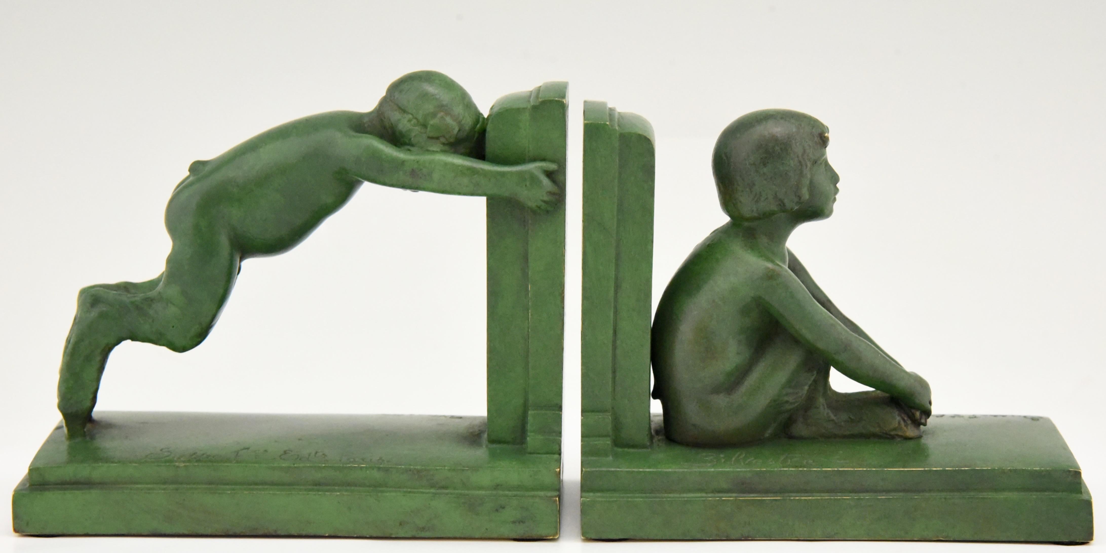 “Sit and push” Art Deco bronze bookends boy and girl satyr.
Signed by Paul Silvestre, with Susse Freres founders' signature, France, circa 1920. Reduced version of the “Miroir d’eau” fountains in Paris and Lucerne.

The bookends are illustrated