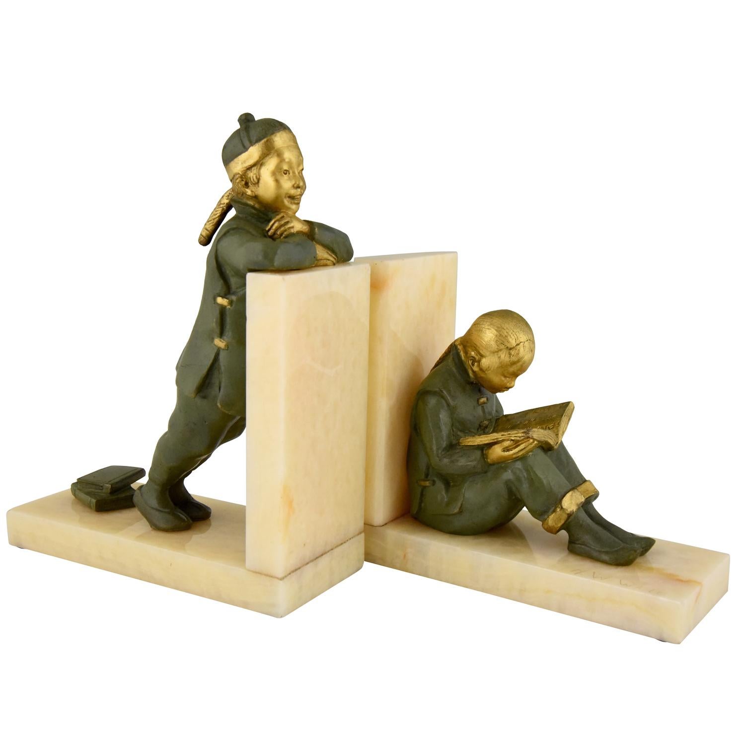 Lovely pair of Art Deco bronze bookends with Chinese students, one is reading the other is standing. The sculpture have a lovely green and golden patina. They are mounted on fine onyx bases, circa 1925.
The bookends are signed by Mabel White, an