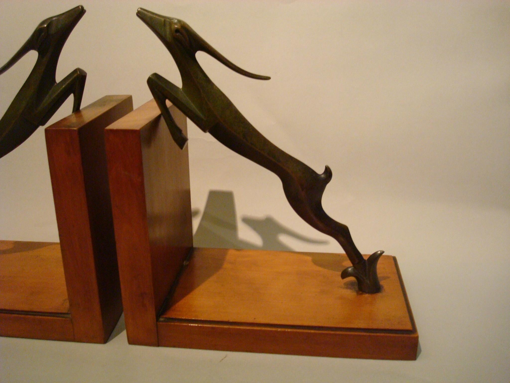 Art Deco bookends slim deer sculpture with wooden base.
They have the Hagenauer style.
Art Deco dark green patinated bronze leaping deer bookends
Unsigned.