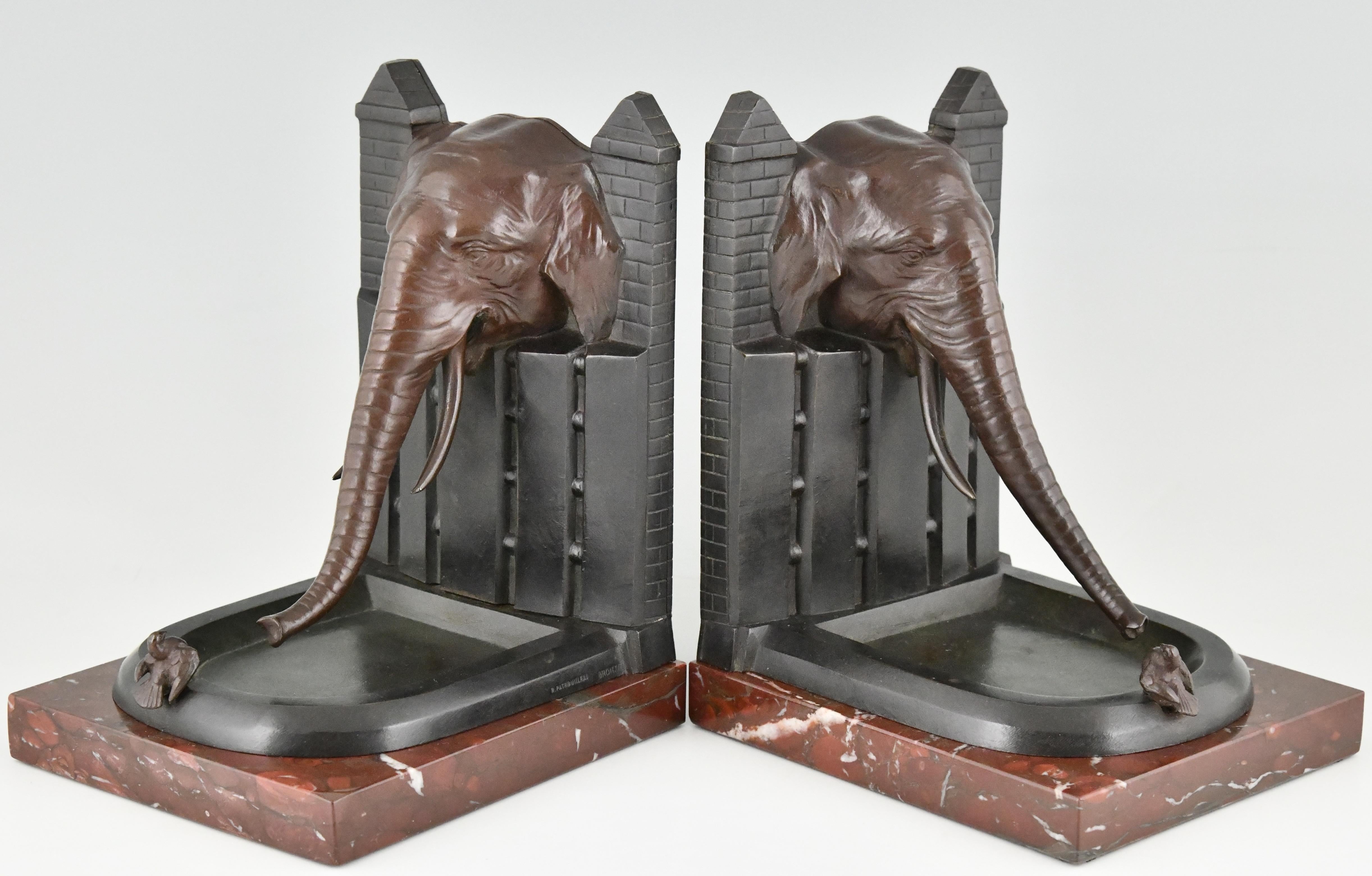 Very nice paire of bronze Art Deco bookends, elephant with bird. 
Signed R. Patrouilleau.
The bronzes have a multi-color patina and are mounted on Belgian Red marble bases. Ca. 1925.
 