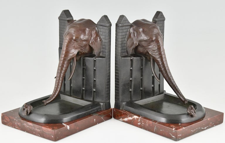 Very nice paire of bronze Art Deco bookends, elephant with bird. 
Signed R. Patrouilleau.
The bronzes have a multi-color patina and are mounted on Belgian Red marble bases. Ca. 1925.
 