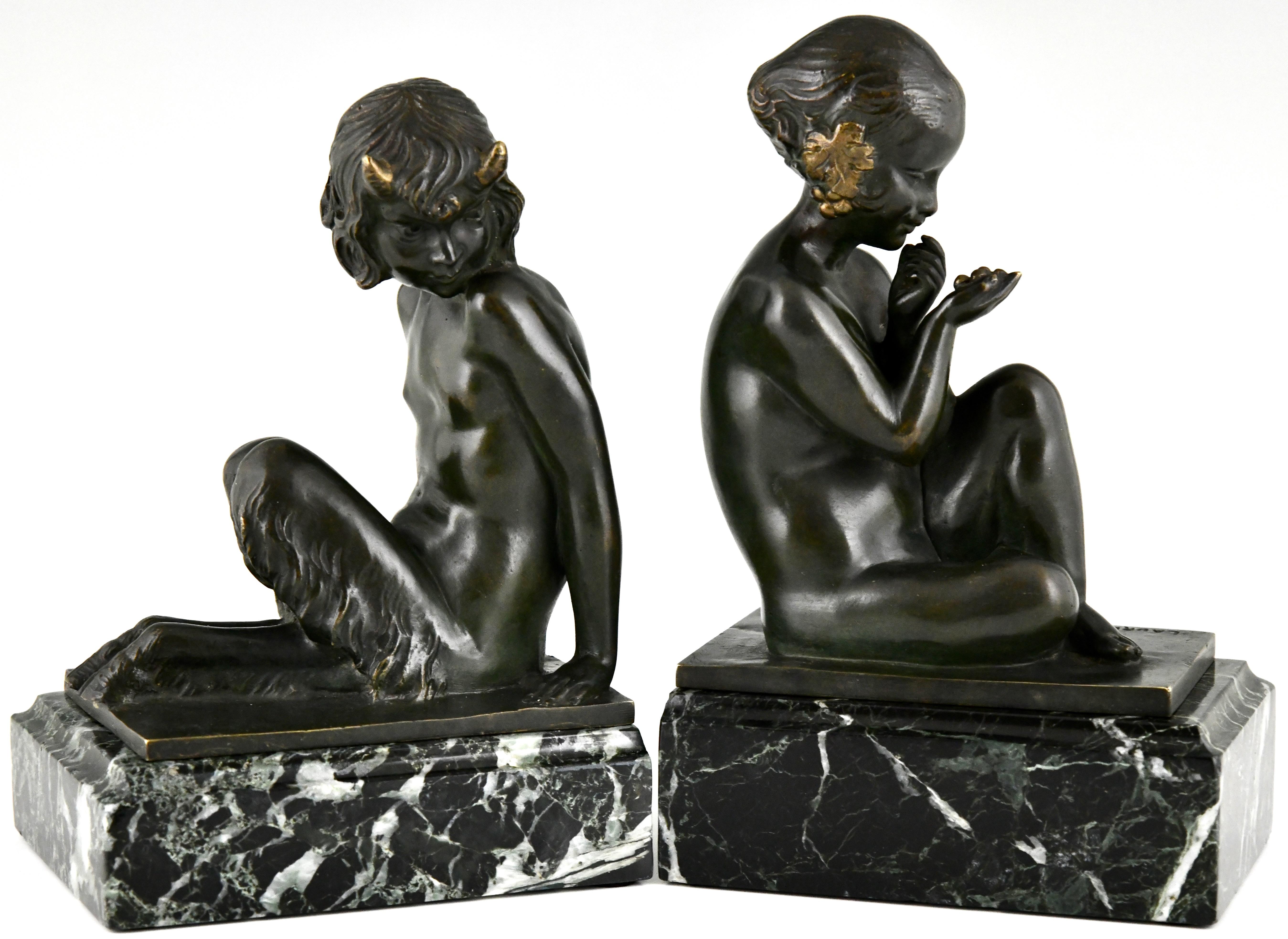 Art Deco bronze bookends faun and girl with grapes by Pierre Laurel. 
Pseudonym of Pierre Le Faguays. 
Signed Laurel & stamped number. 
Patinated bronze on a green marble base. 
France 1925. 
These bookends are illustrated in:
Art Deco and other
