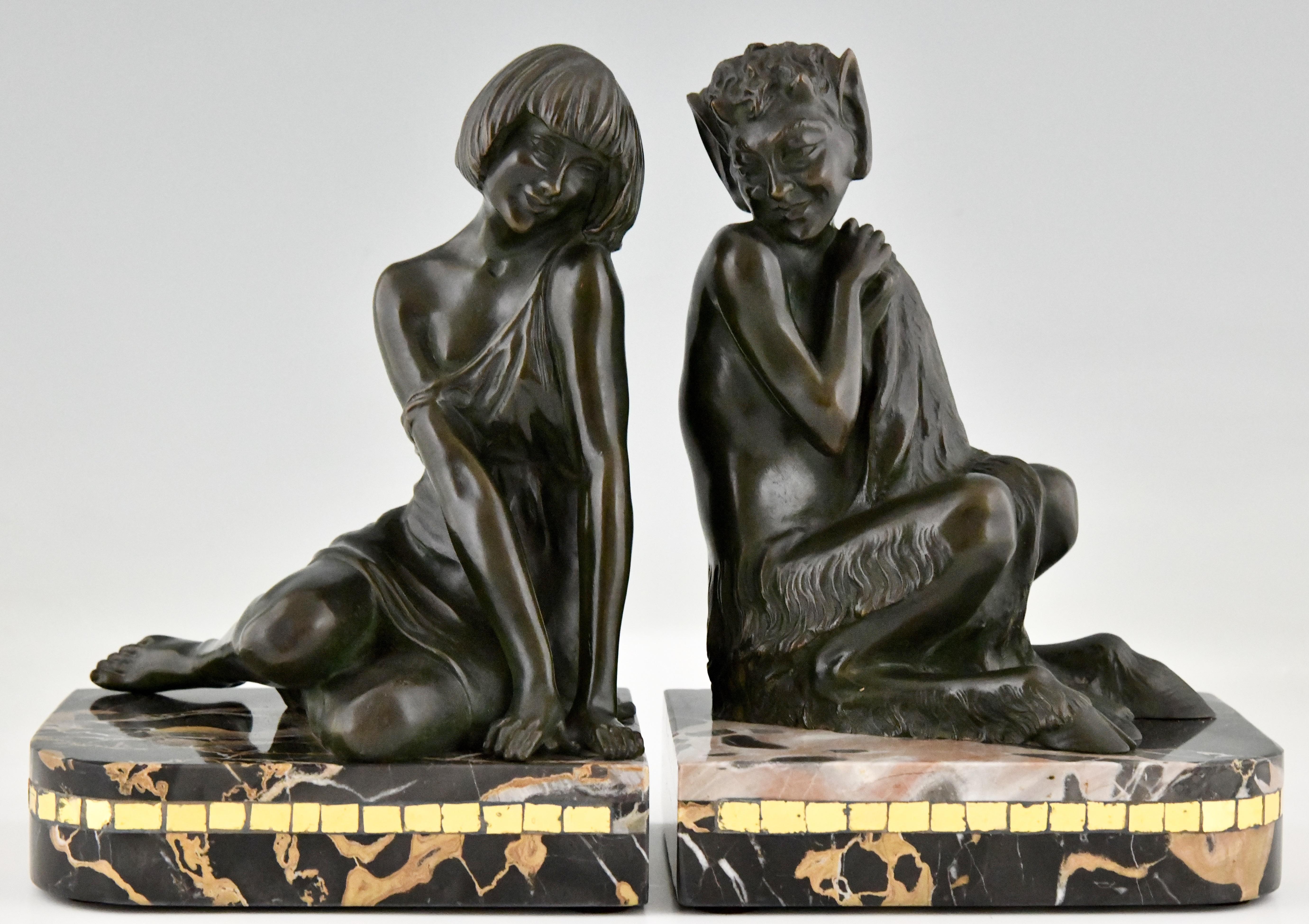Art Deco bronze bookends nymph and faun by Pierre Le Faguays. Patinated bronze on a Portor marble base with glass inlay. France 1925. These bookends are illustrated on page 328 of Art Deco and other figures by Brian Catley, Antique collectors club.