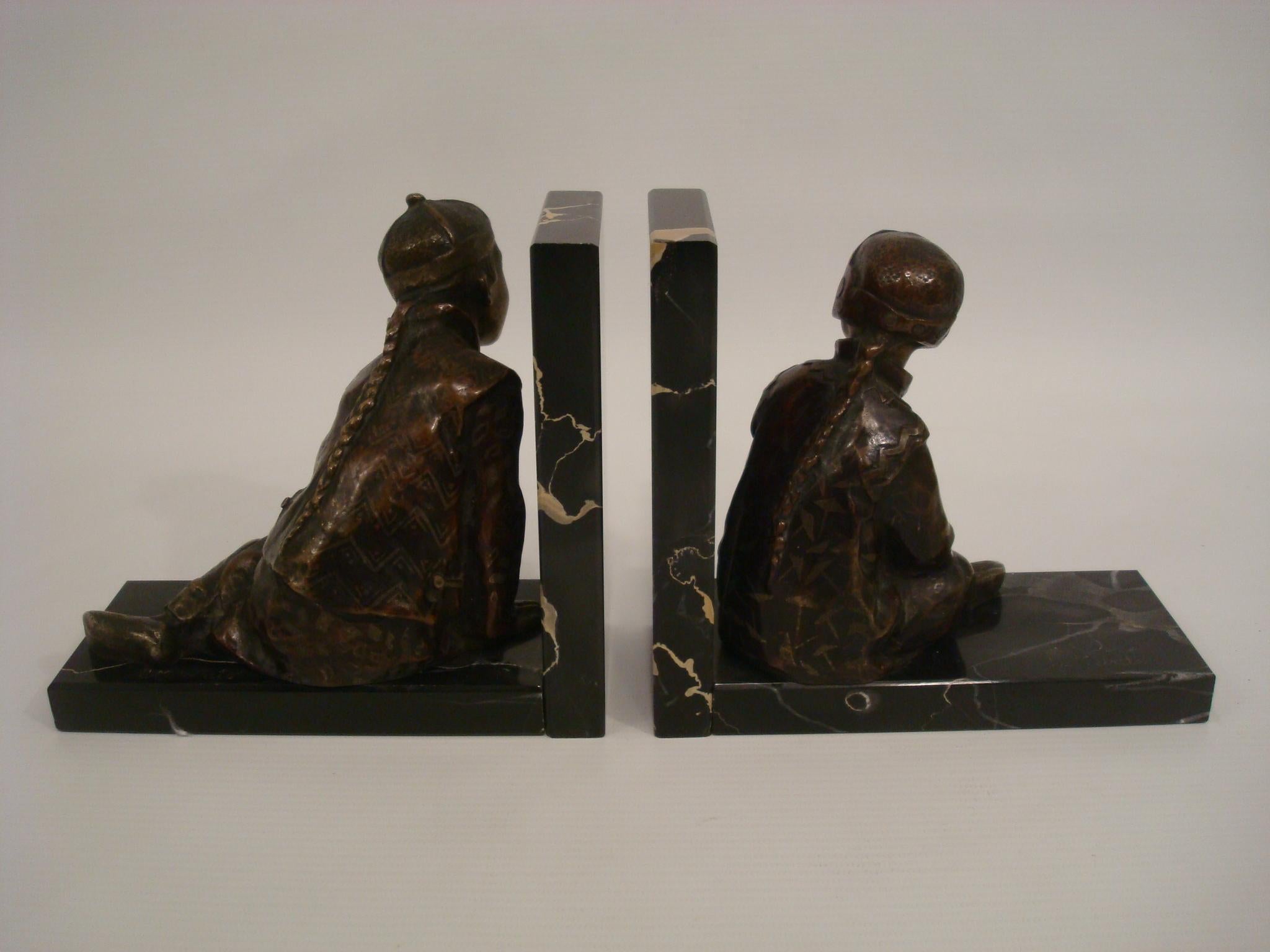 Serre-livres en bronze Art déco représentant des enfants chinois en train de jouer, par M. Whiting, Angleterre, 1920.
Paire de serre-livres en bronze représentant des enfants chinois en train de jouer, l'un jouant avec un ballon, l'autre se cachant.