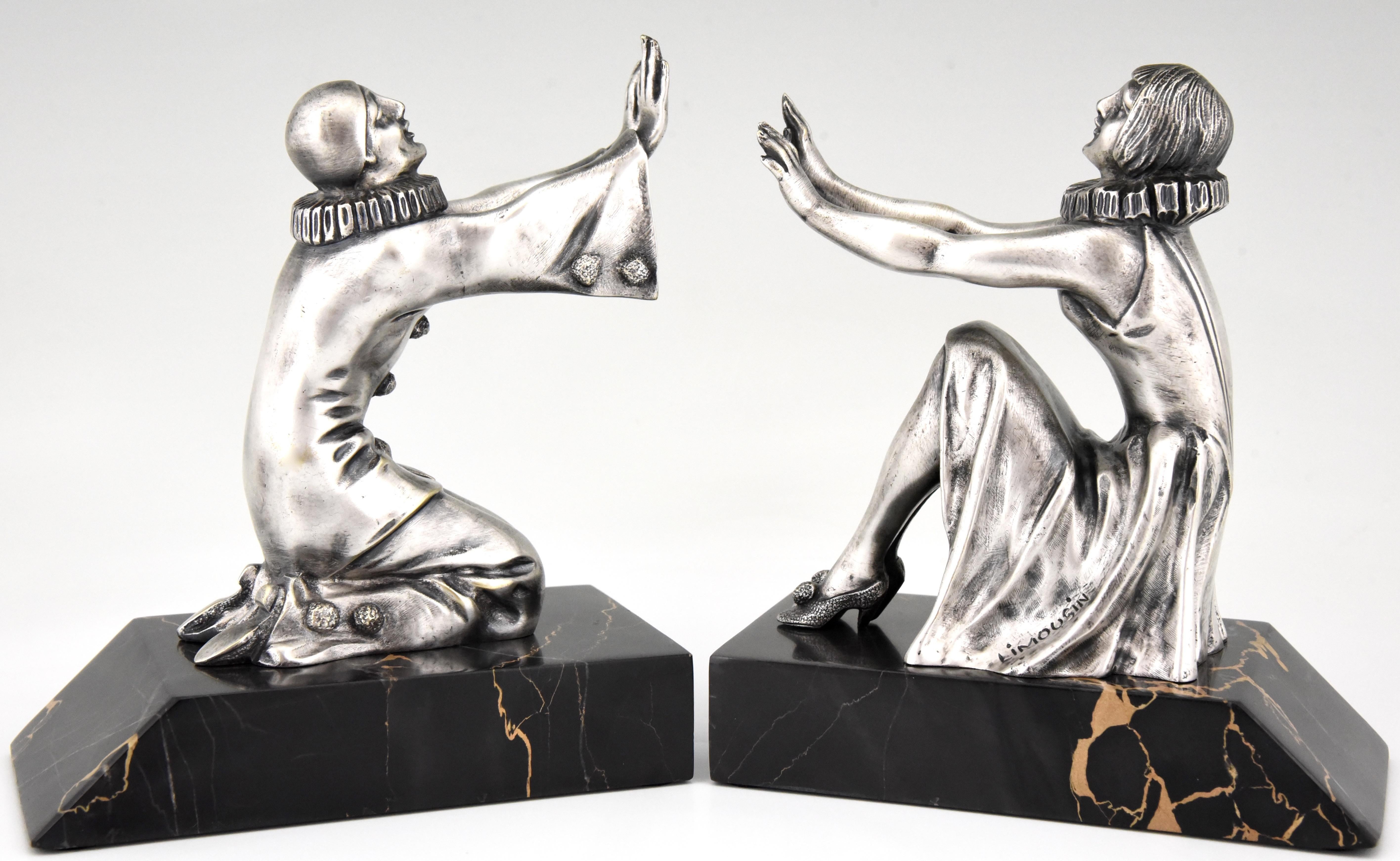 Pair of silvered bronze Art Deco bookends Pierrot and Colombine, female clown by Limousin on a Portor marble base. France circa 1930.