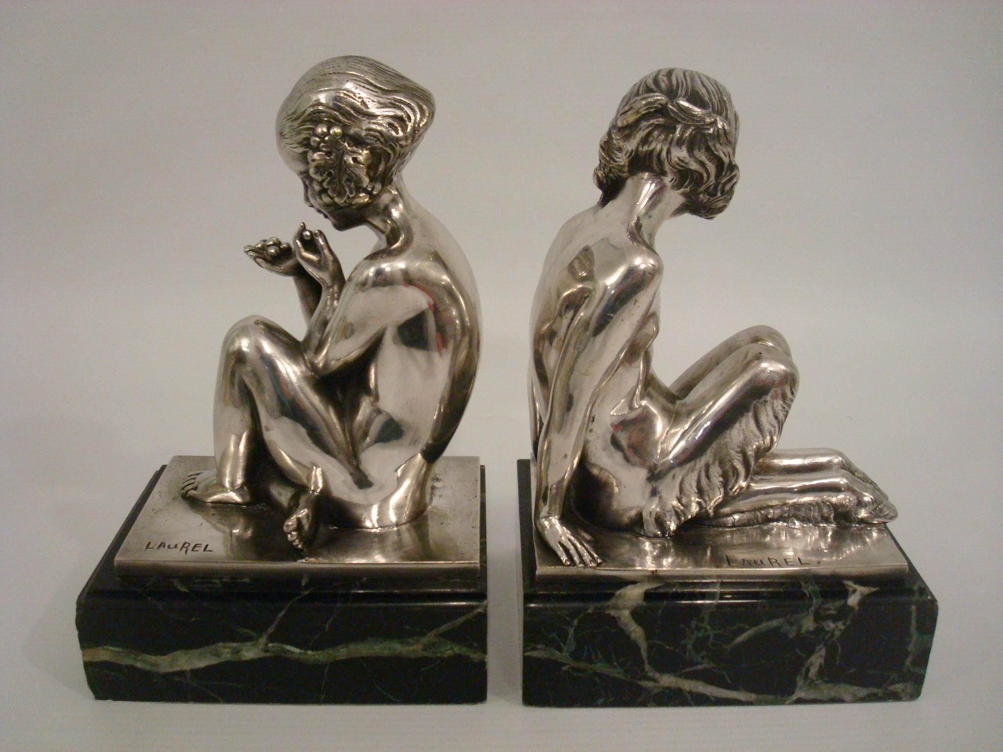 Art Deco Silvered bronze bookends of a young satyr and girl holding grapes. 
By Pierre Laurel. Fantastic Bronze details. Signed Laurel. 
France 1925-1930.
Literature:
“Bronzes, sculptors and founders” by H. Berman
“Art Deco sculpture” by Victor