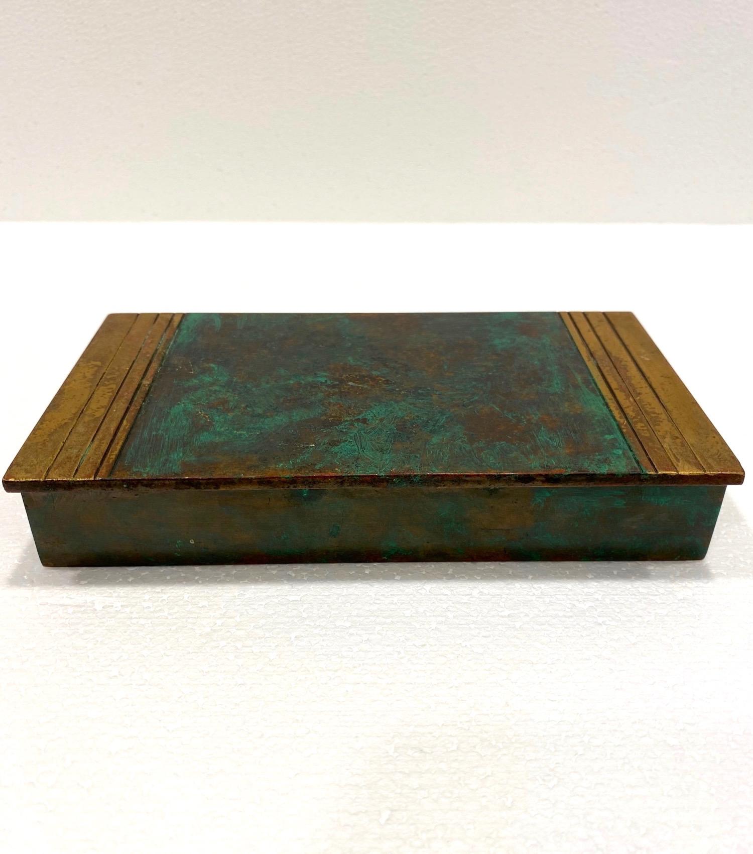 Genuine Art Deco Mid-Century Modern bronze box. Handcrafted box features hinged lid with beautiful green patina throughout, and incised geometric lines along the top. The oxidized patina and visible signs of age adds to the beauty and allure to this