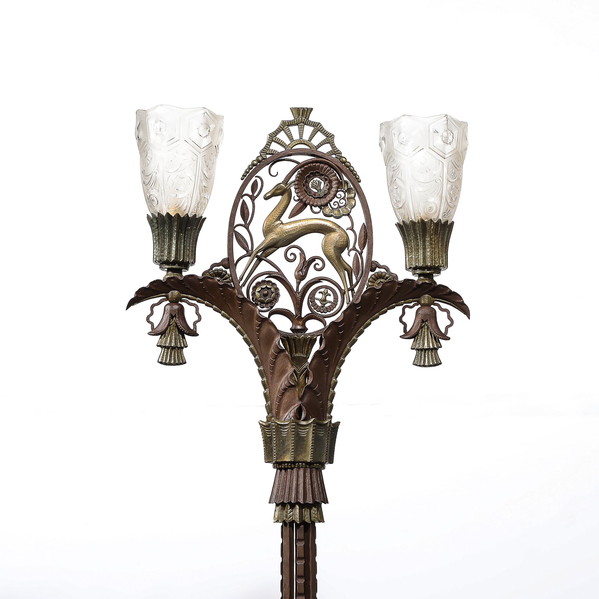 This exquisite and exceedingly rare Art Deco Bronze & Brass Floor Lamp W/Frosted Glass Shades signed Edgar Brandt originates from France, Circa 1930. This floor lamp is highly ornate, featuring in the center between the shades a stylized Gazelle