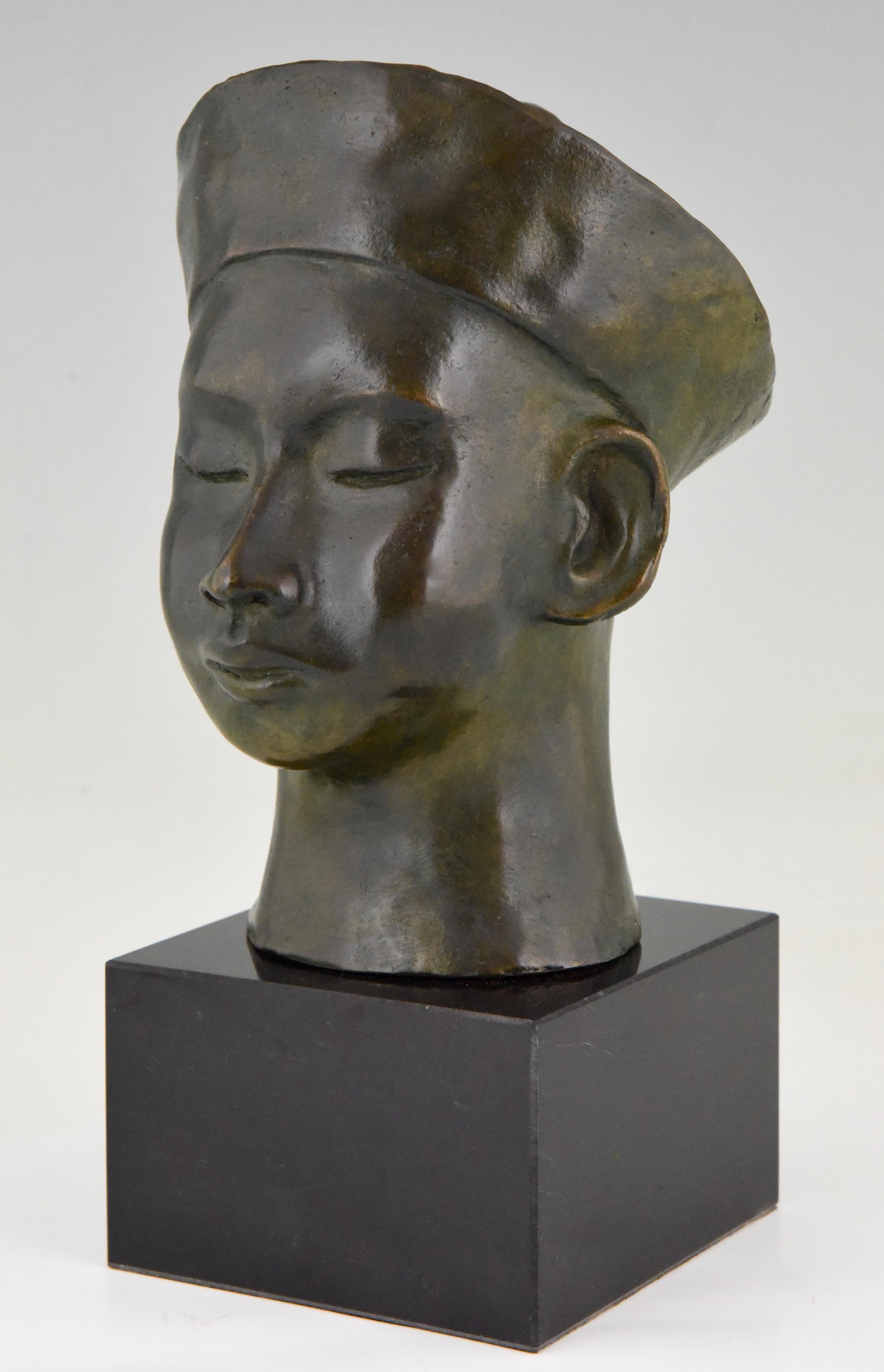 Art Deco bronze bust of a young Chinese boy with hat and queue hairstyle, braid- signed by C. Le Van and numbered.
Beautiful green patina on black marble base.
 