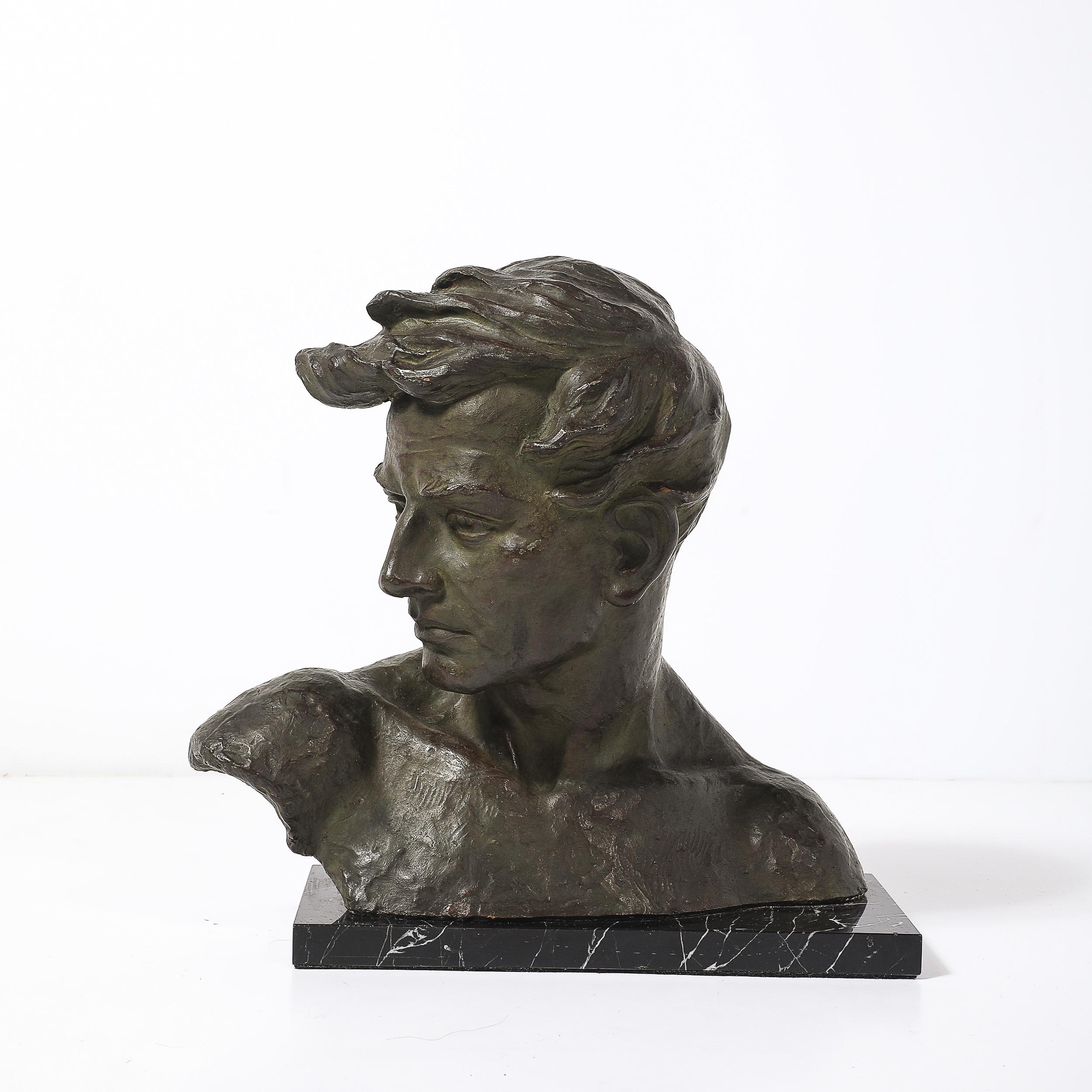 This captivating Art Deco bronze bust of a male figure is a striking example of the elegance and craftsmanship characteristic of the 1930s. The piece, sculpted by renowned Belgian artist Johannes Dommisse, captures the dignified features and strong
